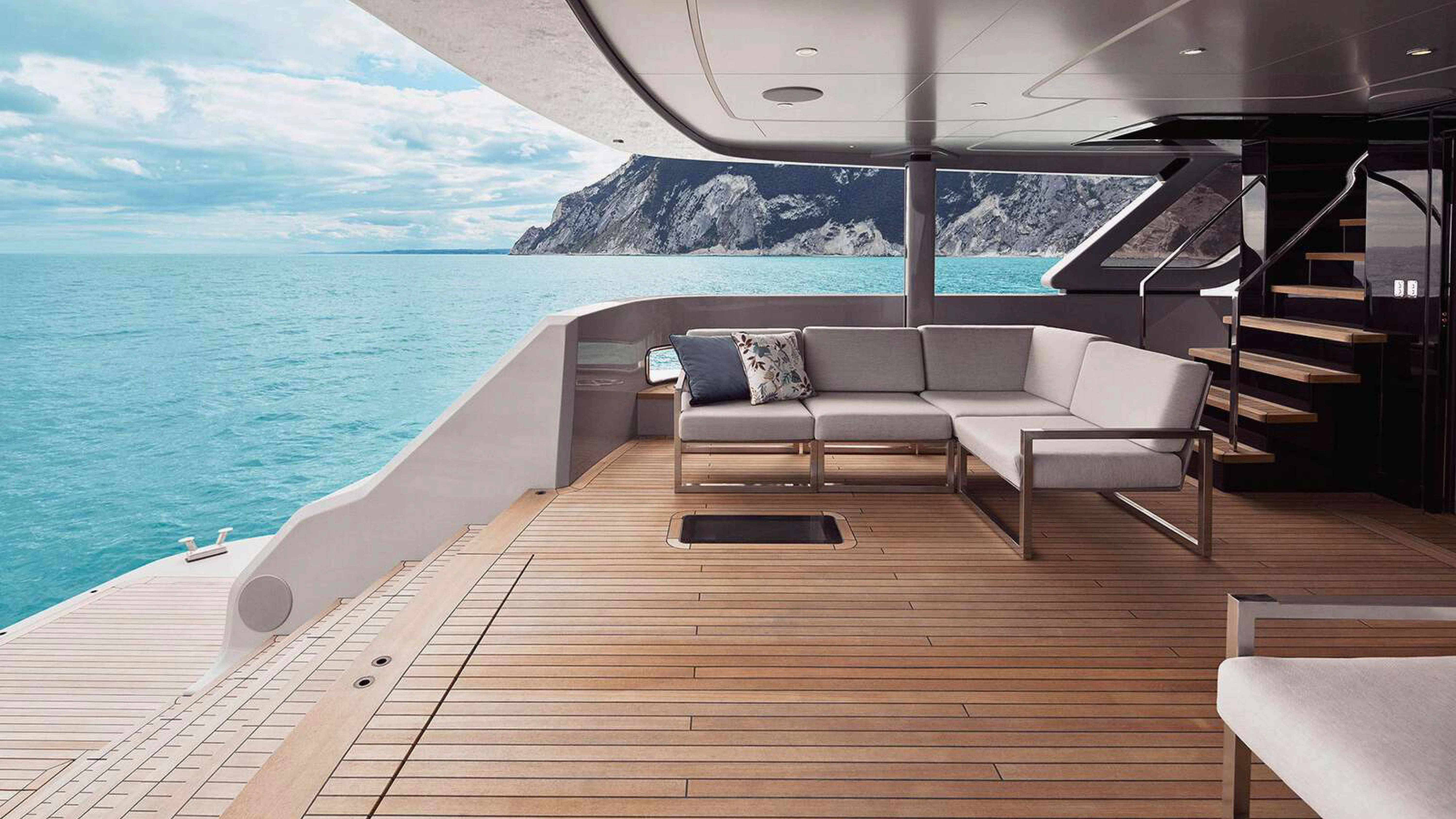 a deck with chairs and a body of water aboard PAZIENZA Yacht for Charter