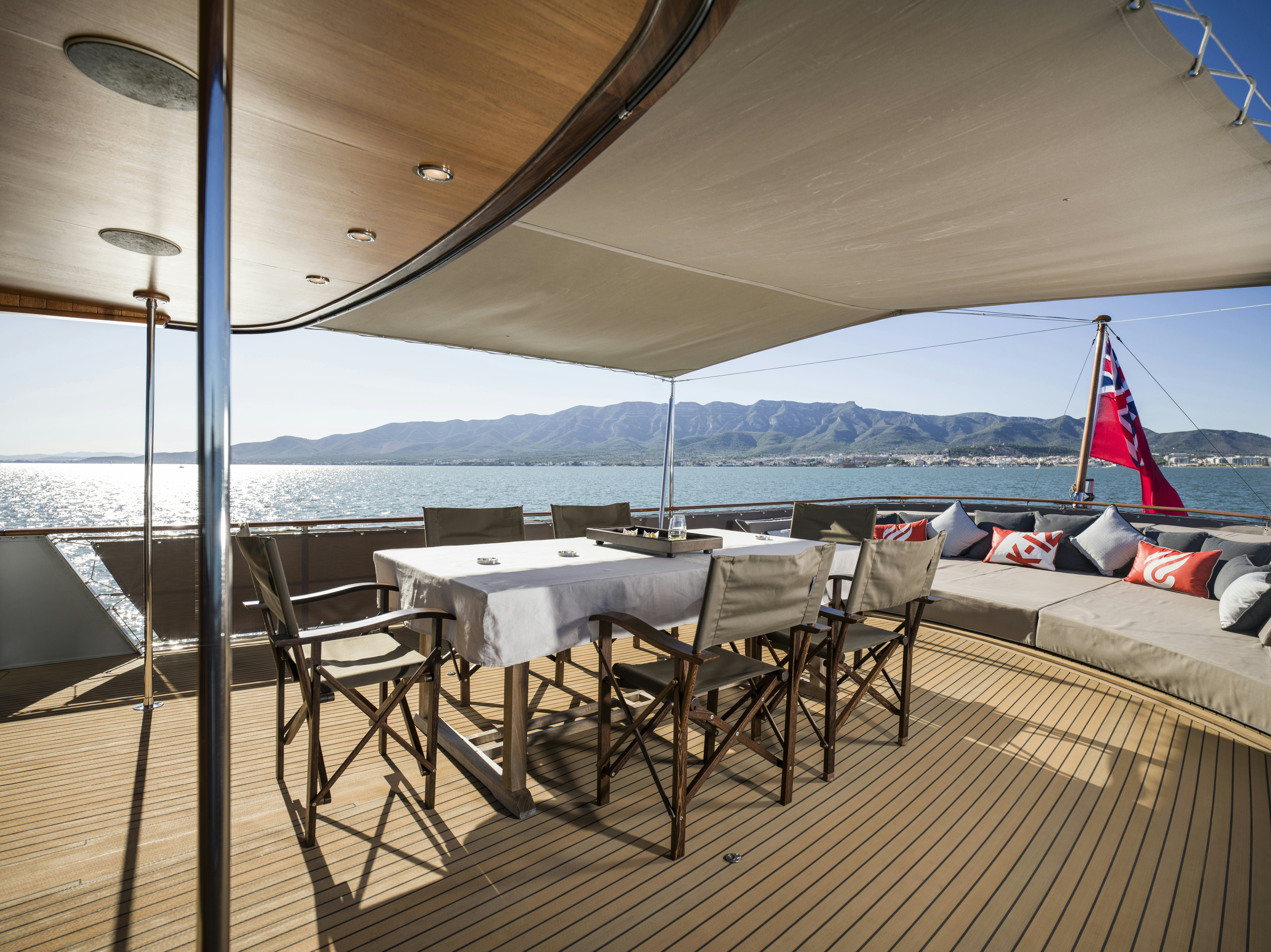 a deck with a table and chairs aboard LA FENICE Yacht for Sale
