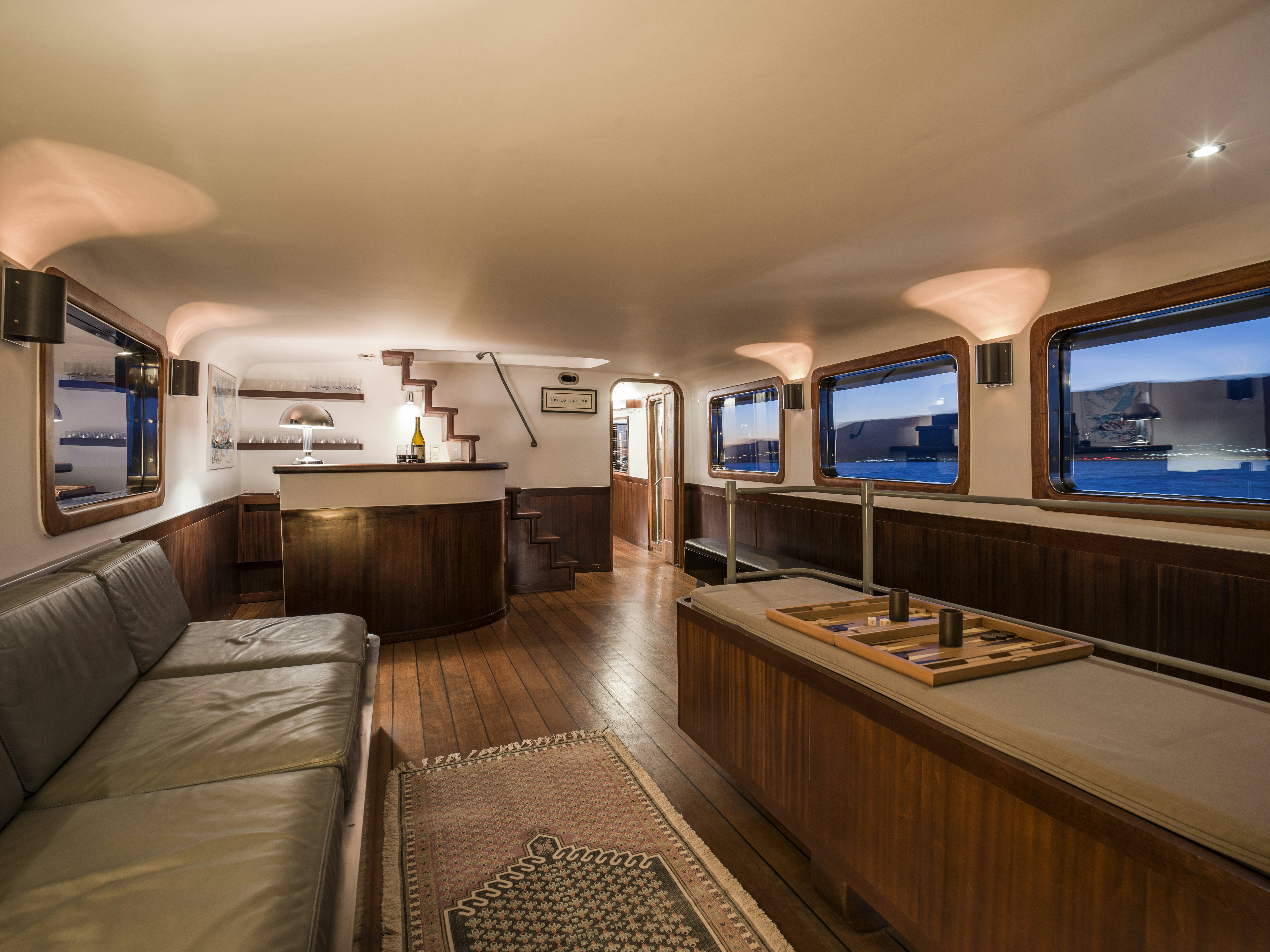 a room with a couch and a tv on the wall aboard LA FENICE Yacht for Sale