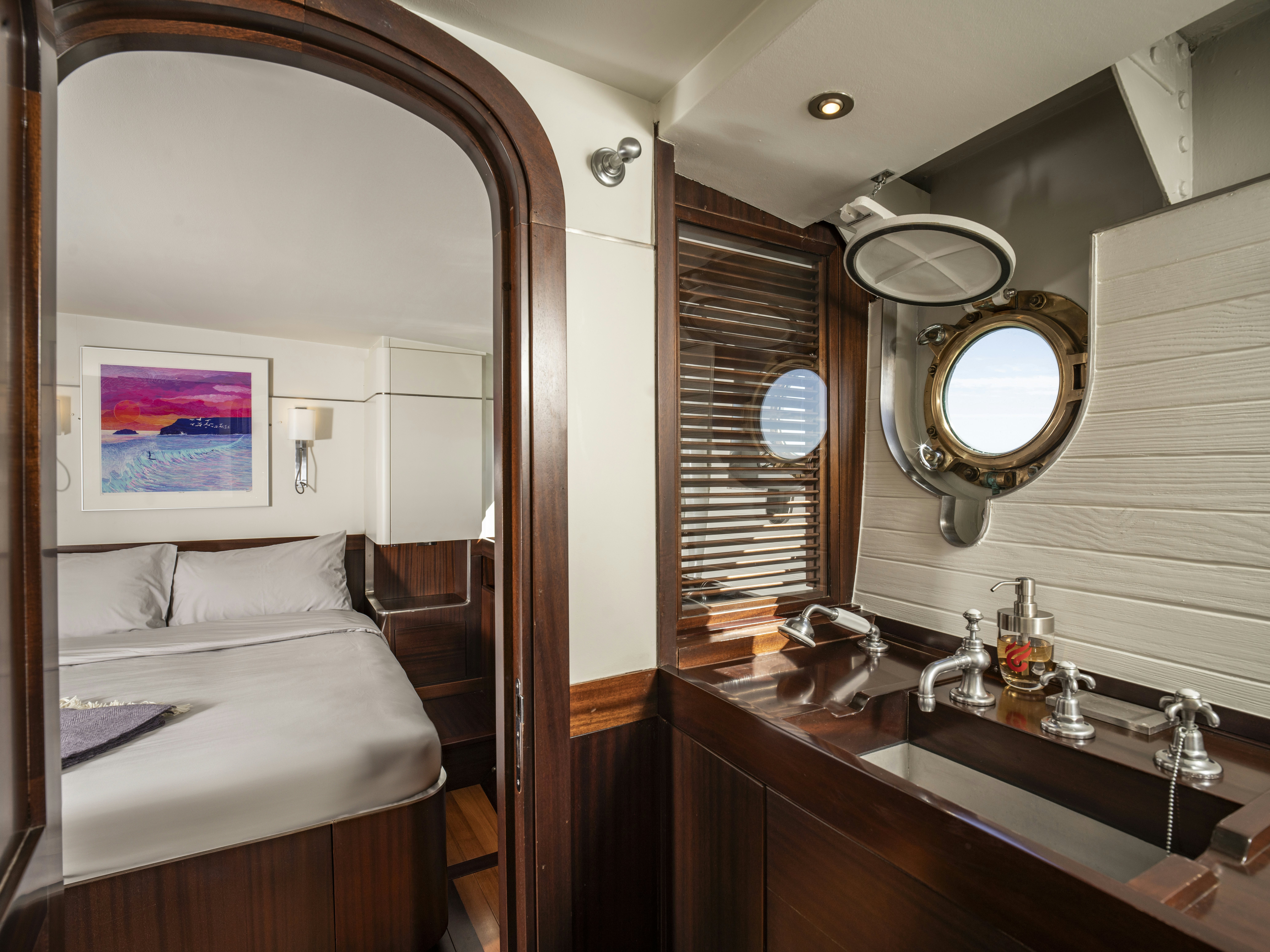 a bathroom with a sink and a bed aboard LA FENICE Yacht for Sale