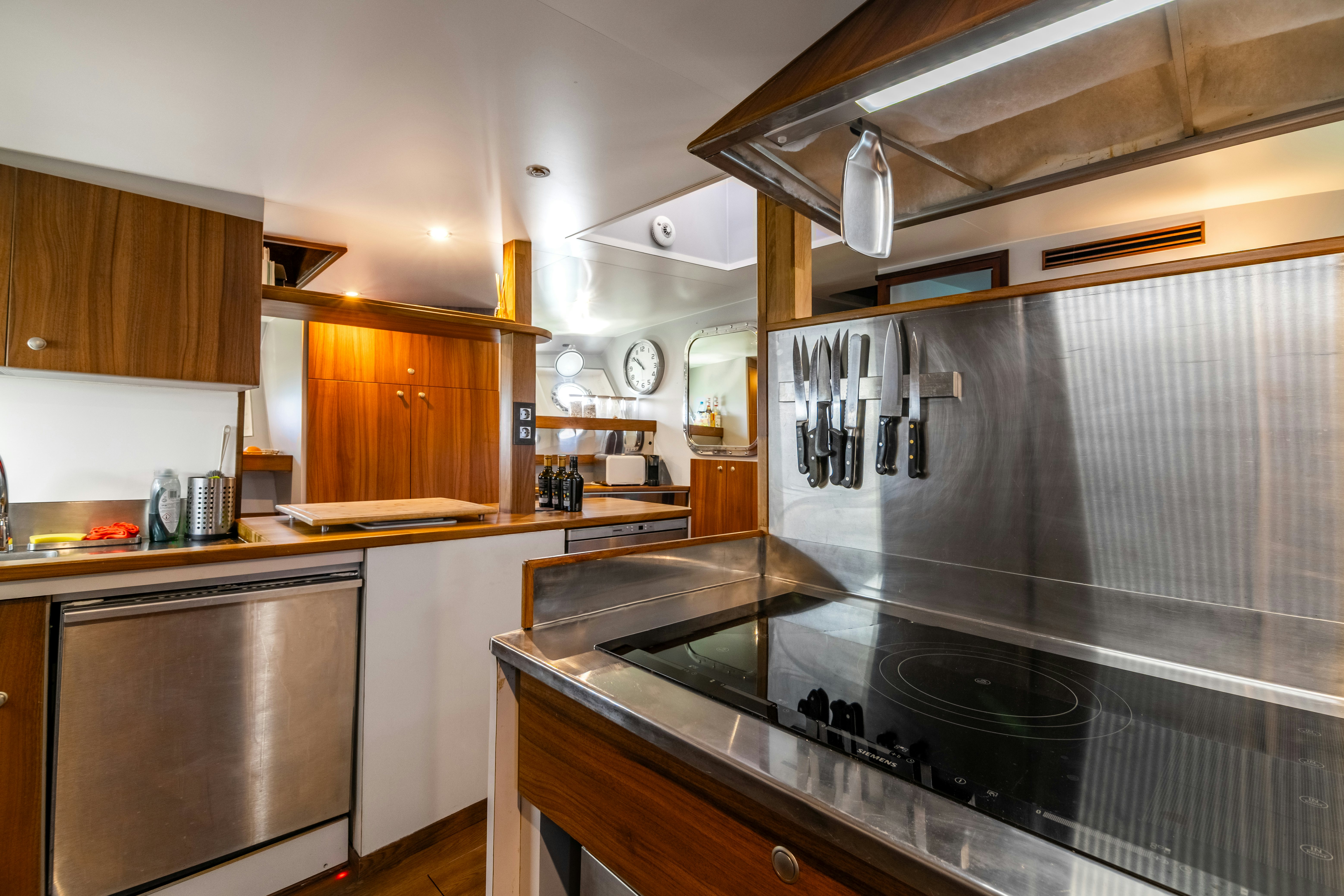 a kitchen with stainless steel appliances aboard LA FENICE Yacht for Sale
