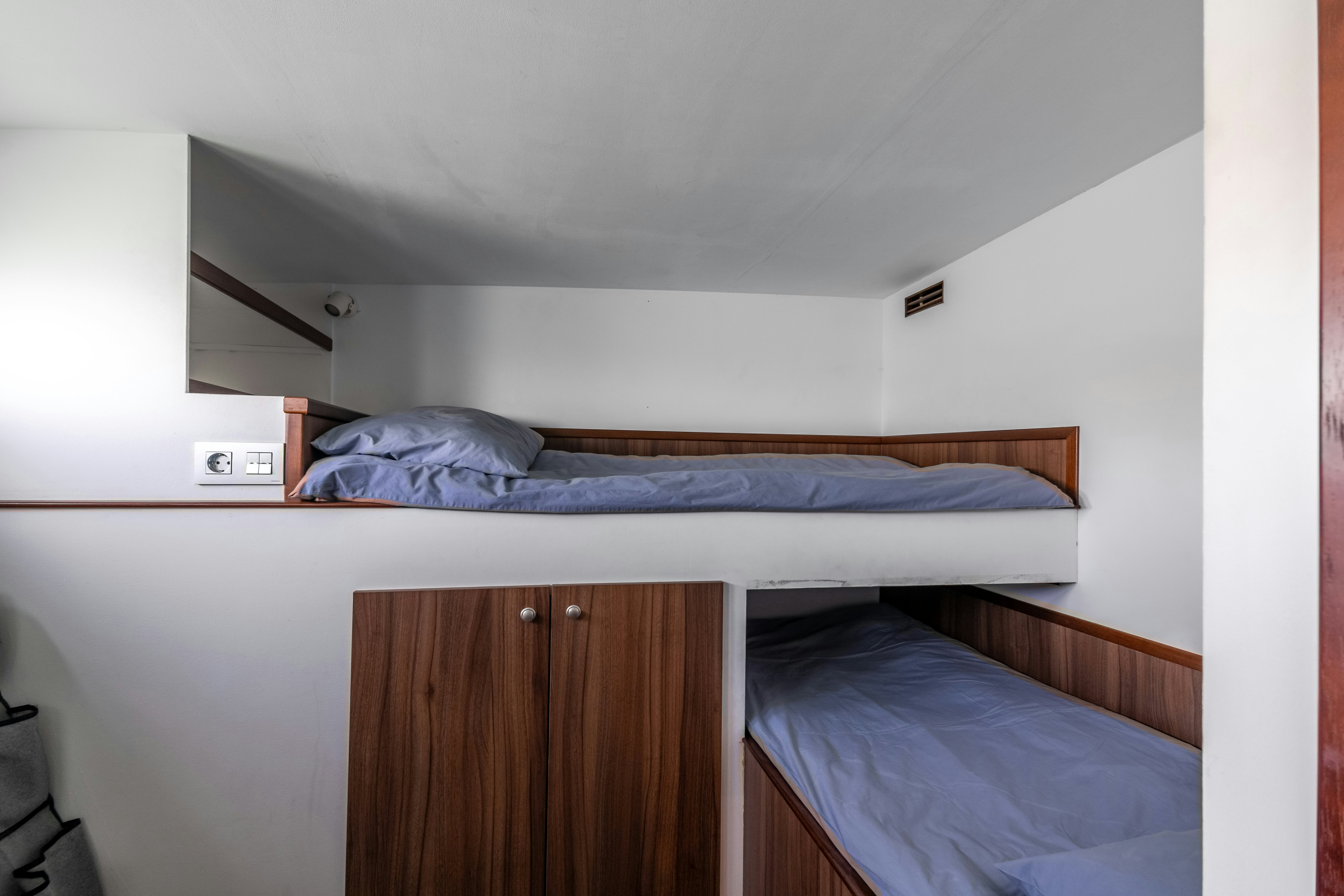 a bedroom with a bed and a shelf aboard LA FENICE Yacht for Sale