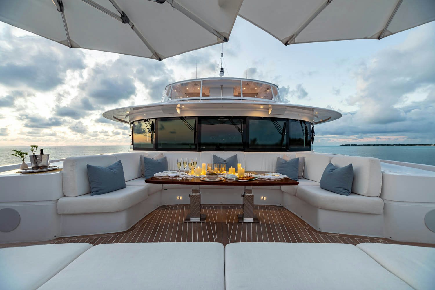 a white couch and a table on a boat in the water aboard KING BABY Yacht for Charter