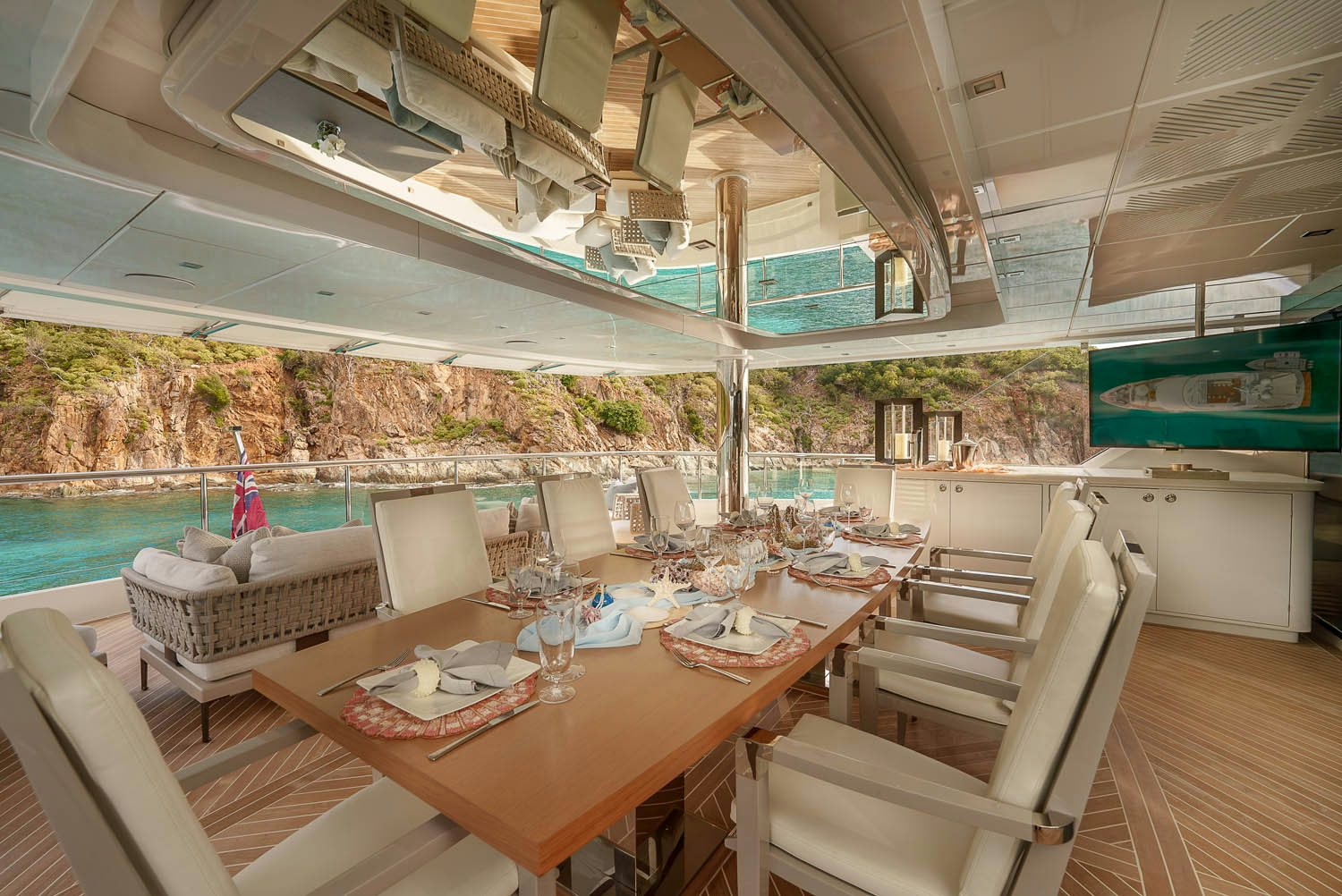 a table with chairs and a view of the water aboard KING BABY Yacht for Charter