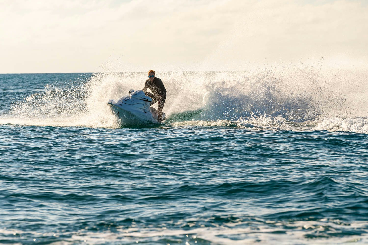 a man surfing on a wave aboard KING BABY Yacht for Charter