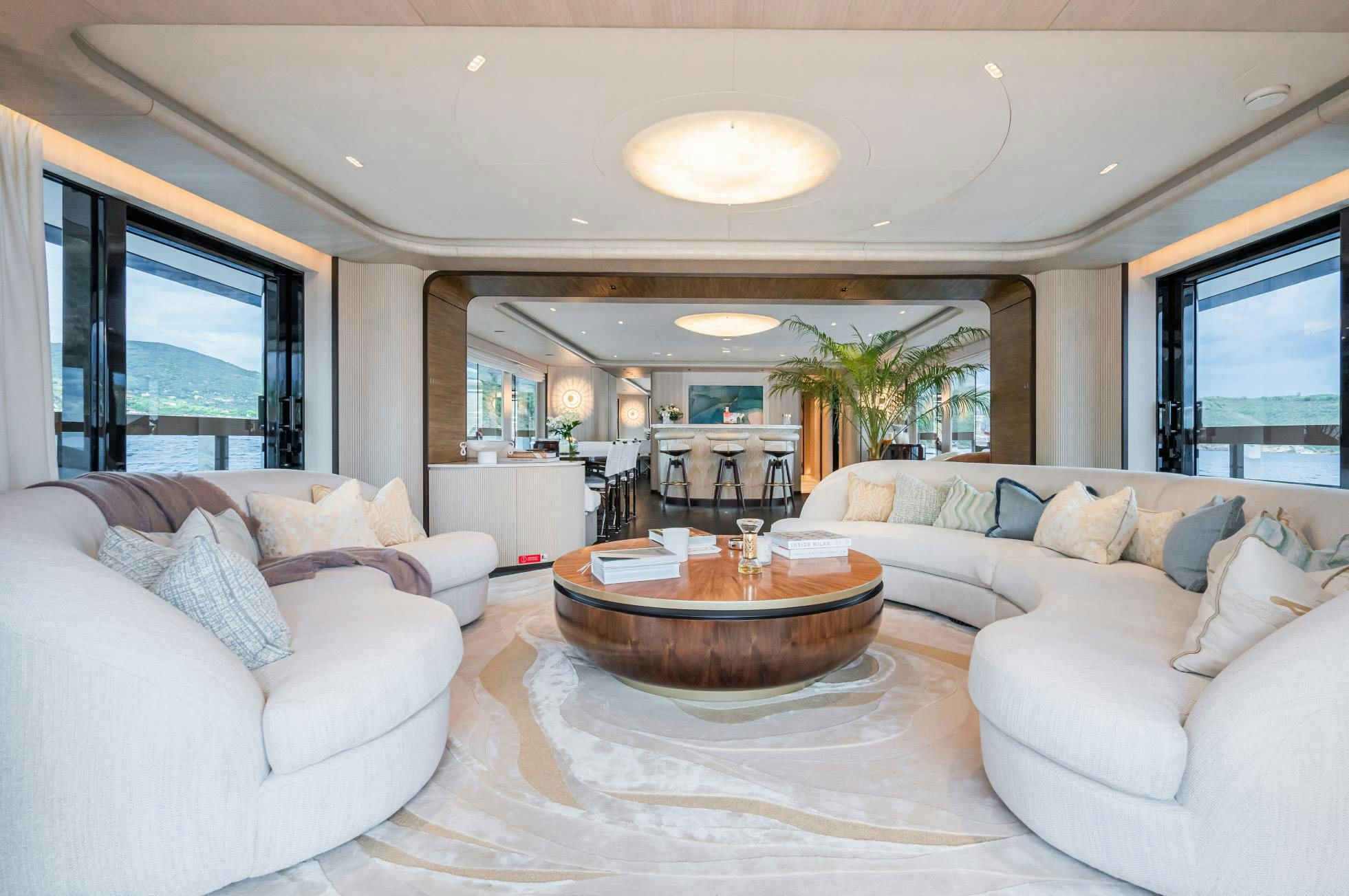 a living room with a table and couches aboard M Yacht for Sale