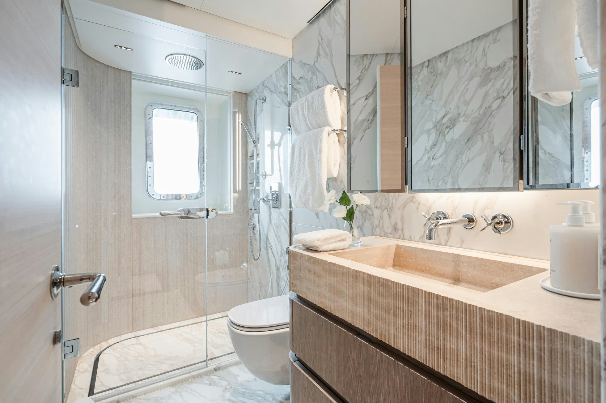 a bathroom with a glass shower door aboard M Yacht for Sale