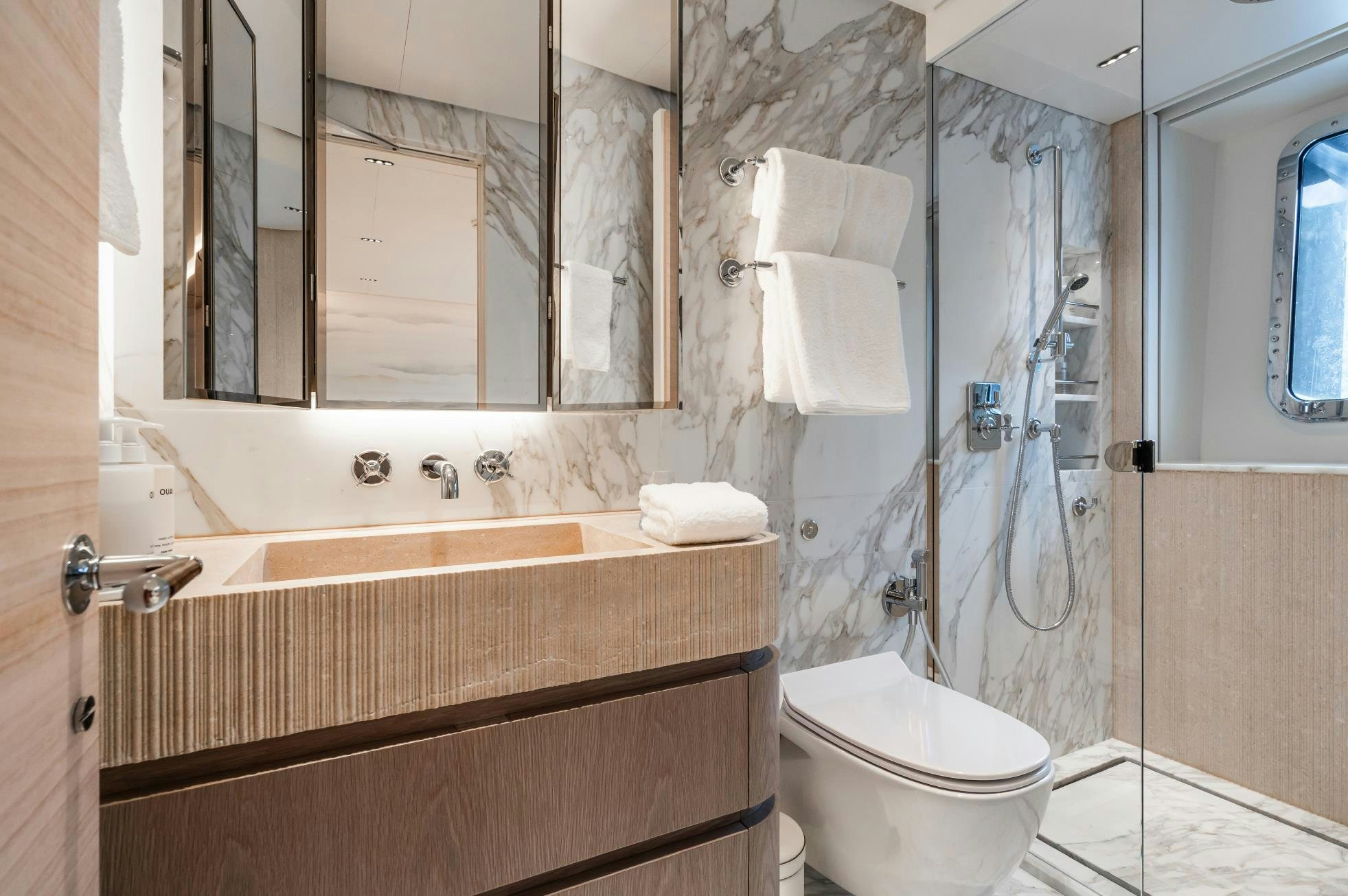 a bathroom with a glass shower aboard M Yacht for Sale