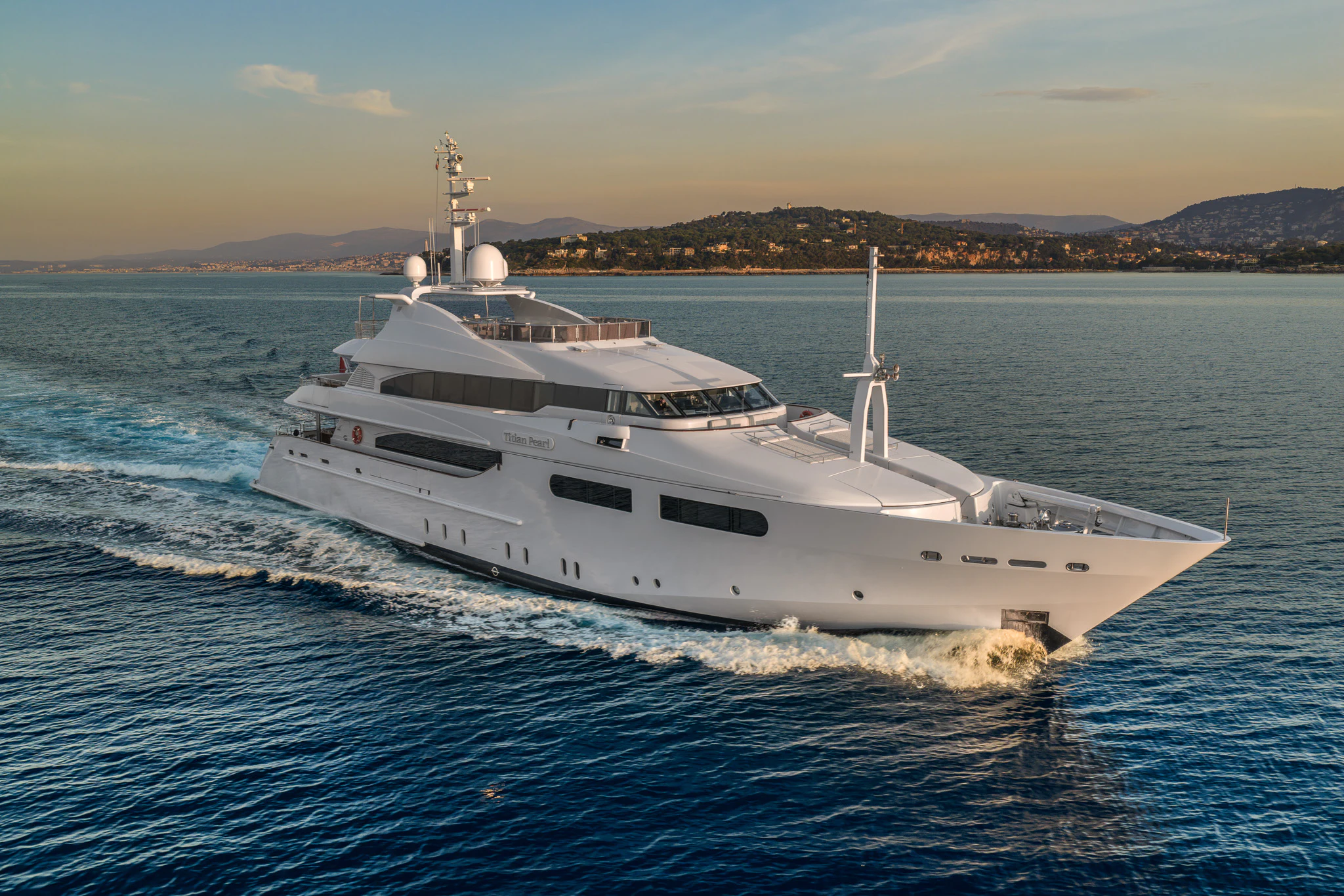 a white yacht on the water aboard TITIAN PEARL Yacht for Sale