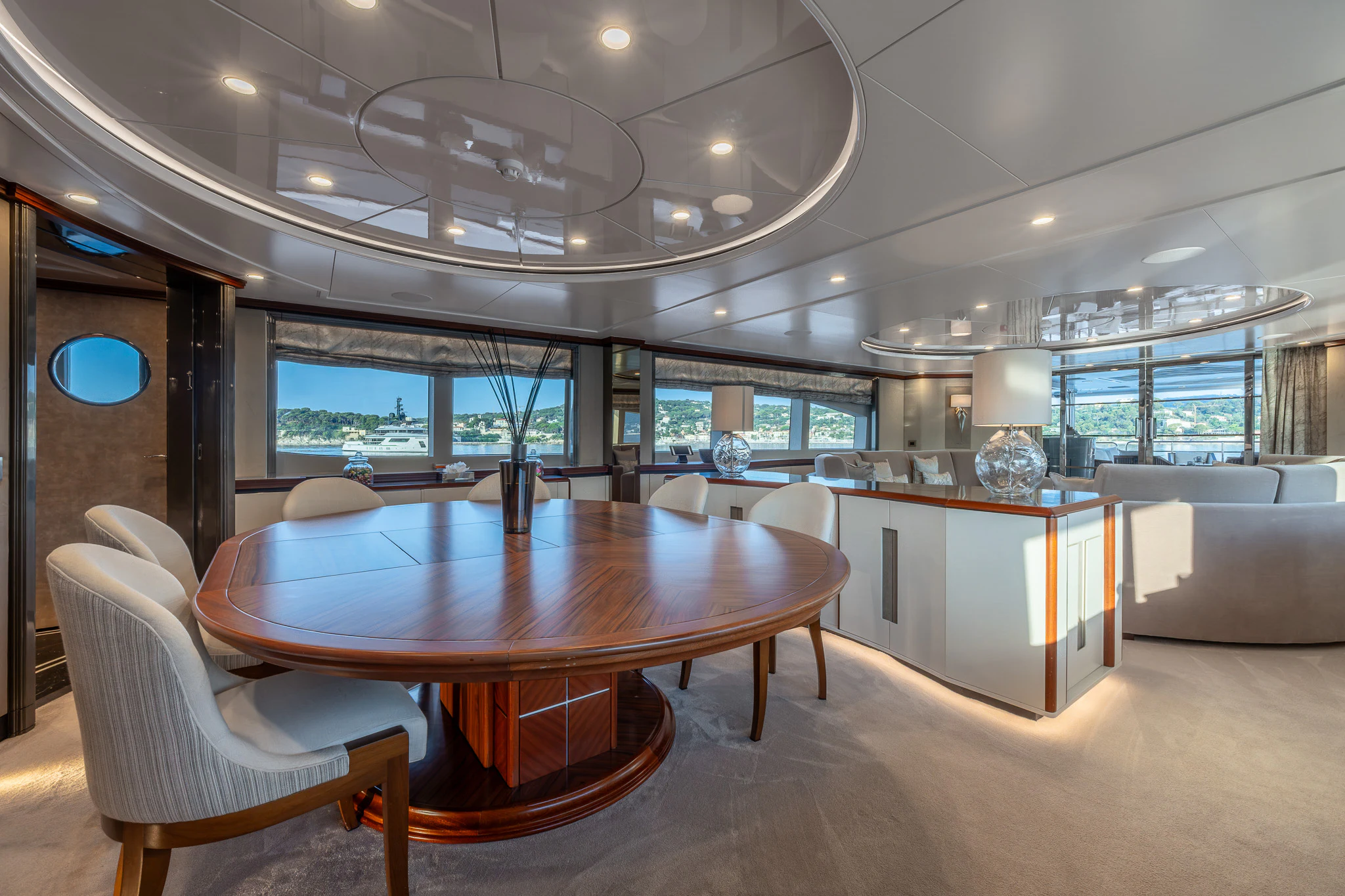 a large room with a table and chairs aboard TITIAN PEARL Yacht for Sale