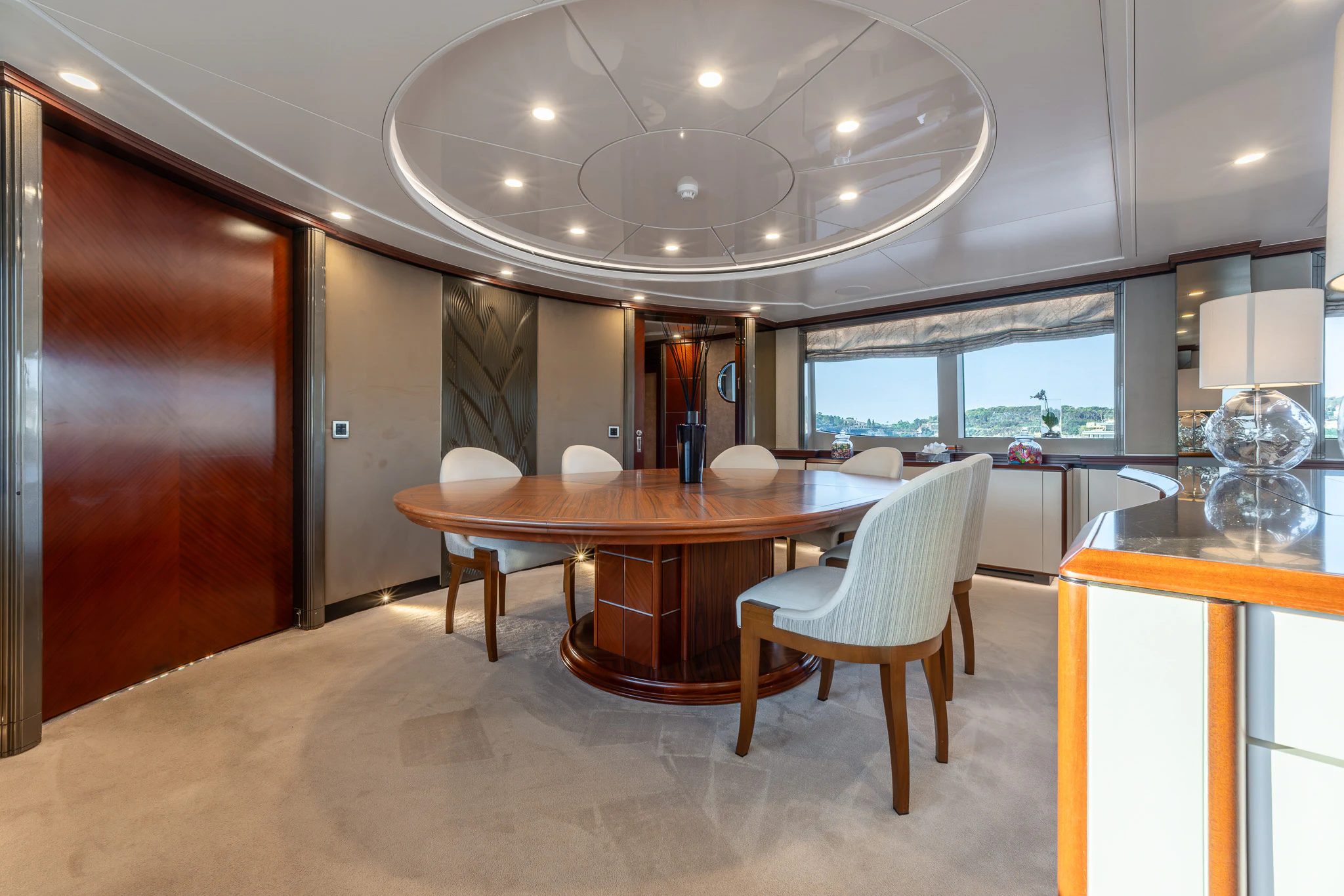 a large room with a table and chairs aboard TITIAN PEARL Yacht for Sale