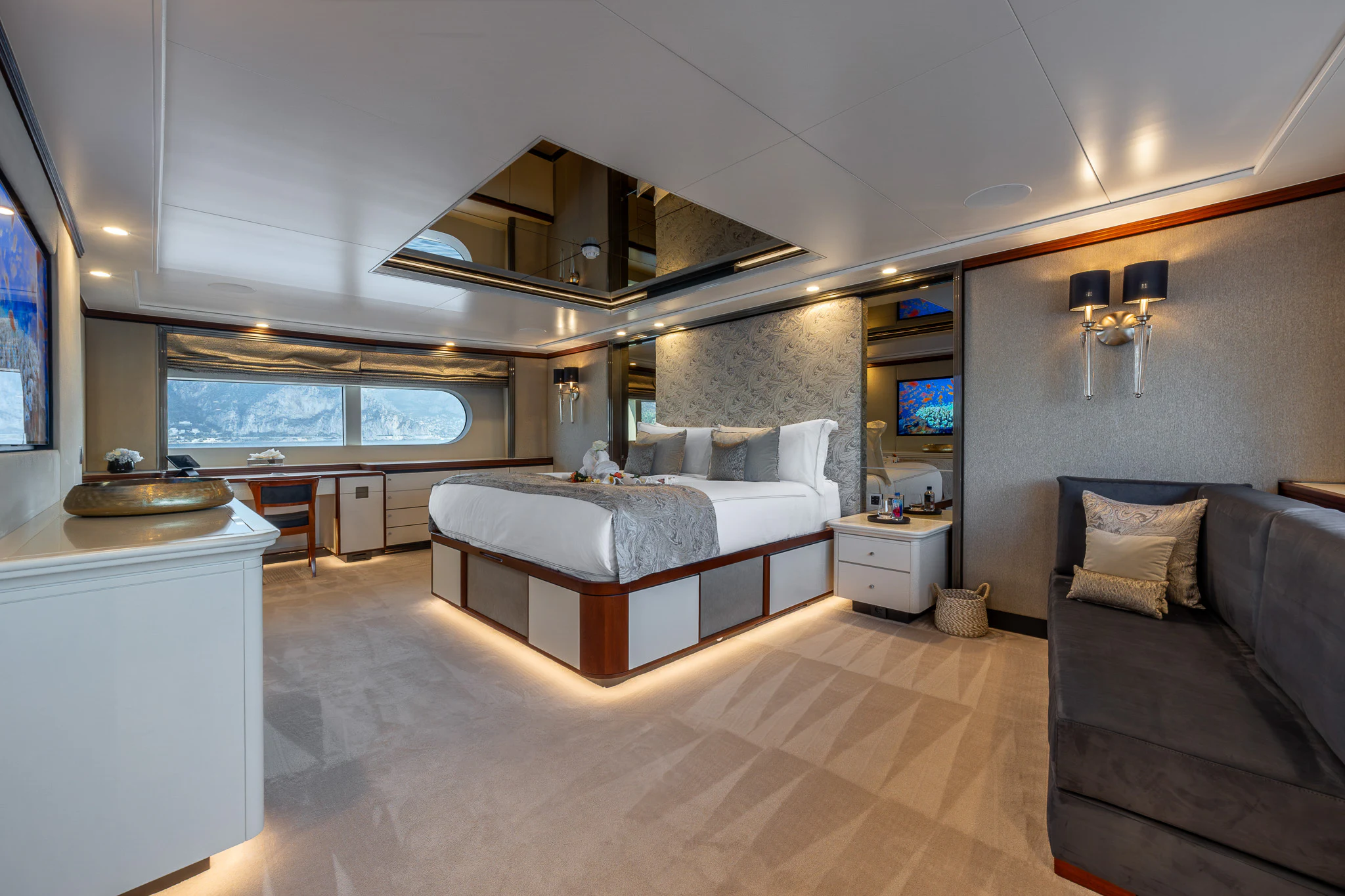 a bedroom with a bed and a couch aboard TITIAN PEARL Yacht for Sale