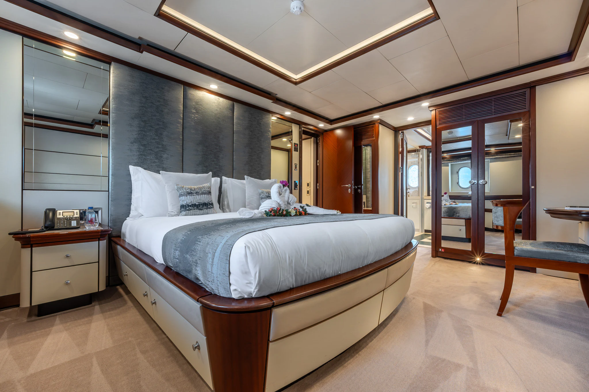 a large bedroom with a large bed aboard TITIAN PEARL Yacht for Sale