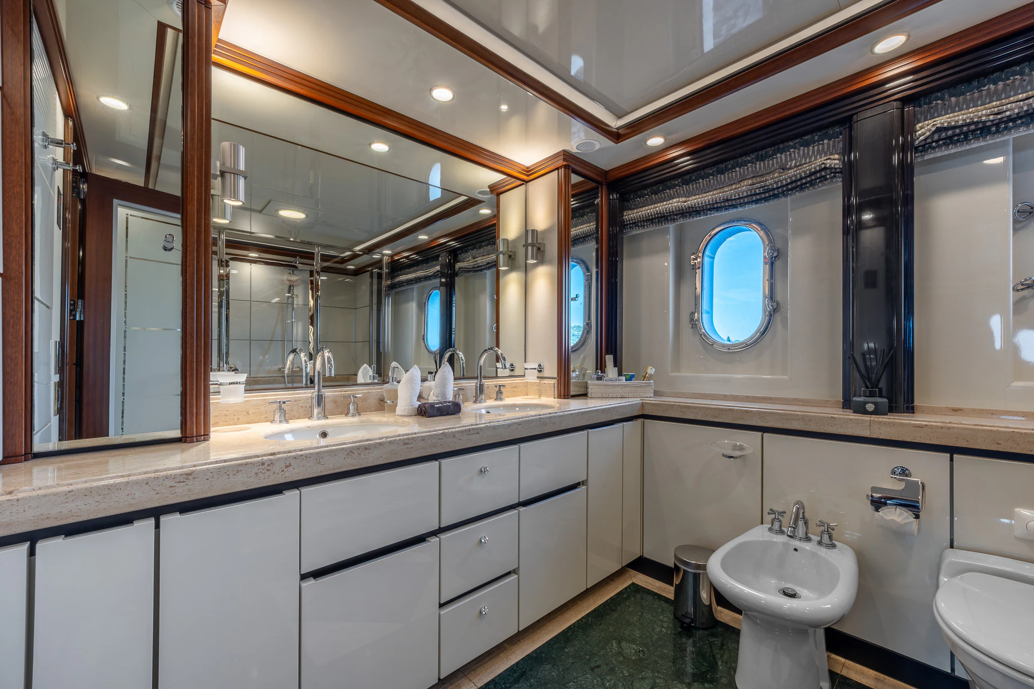 a bathroom with a large mirror aboard TITIAN PEARL Yacht for Sale