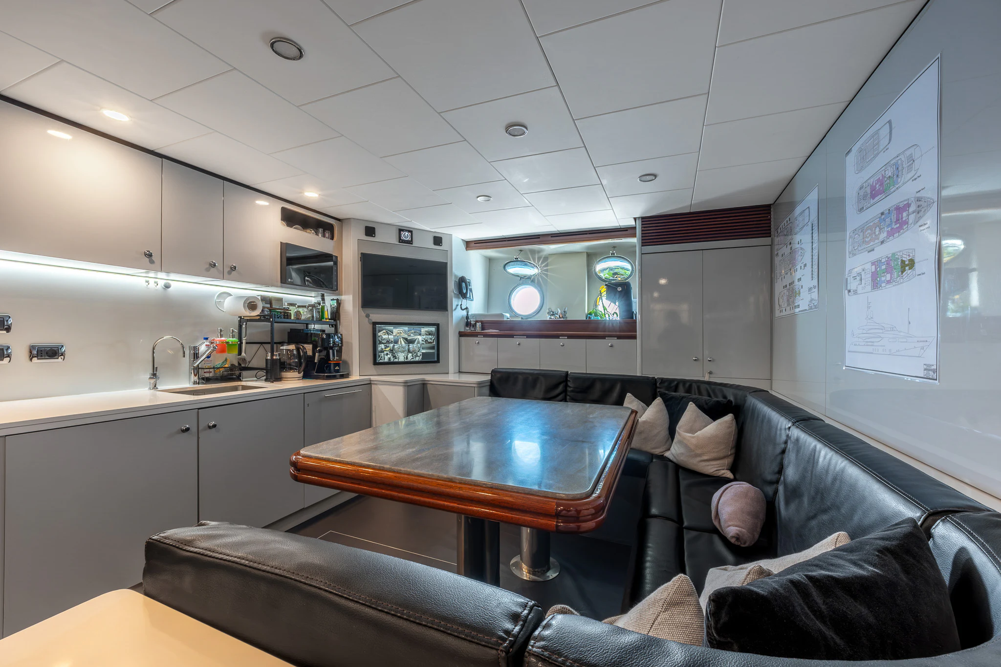 a room with a couch and a table aboard TITIAN PEARL Yacht for Sale