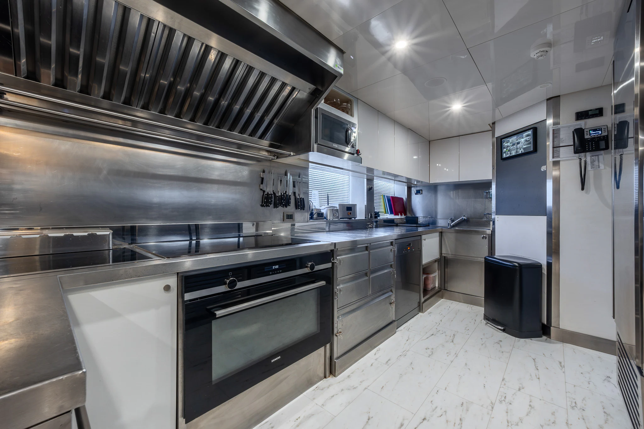 a large kitchen with stainless steel appliances aboard TITIAN PEARL Yacht for Sale