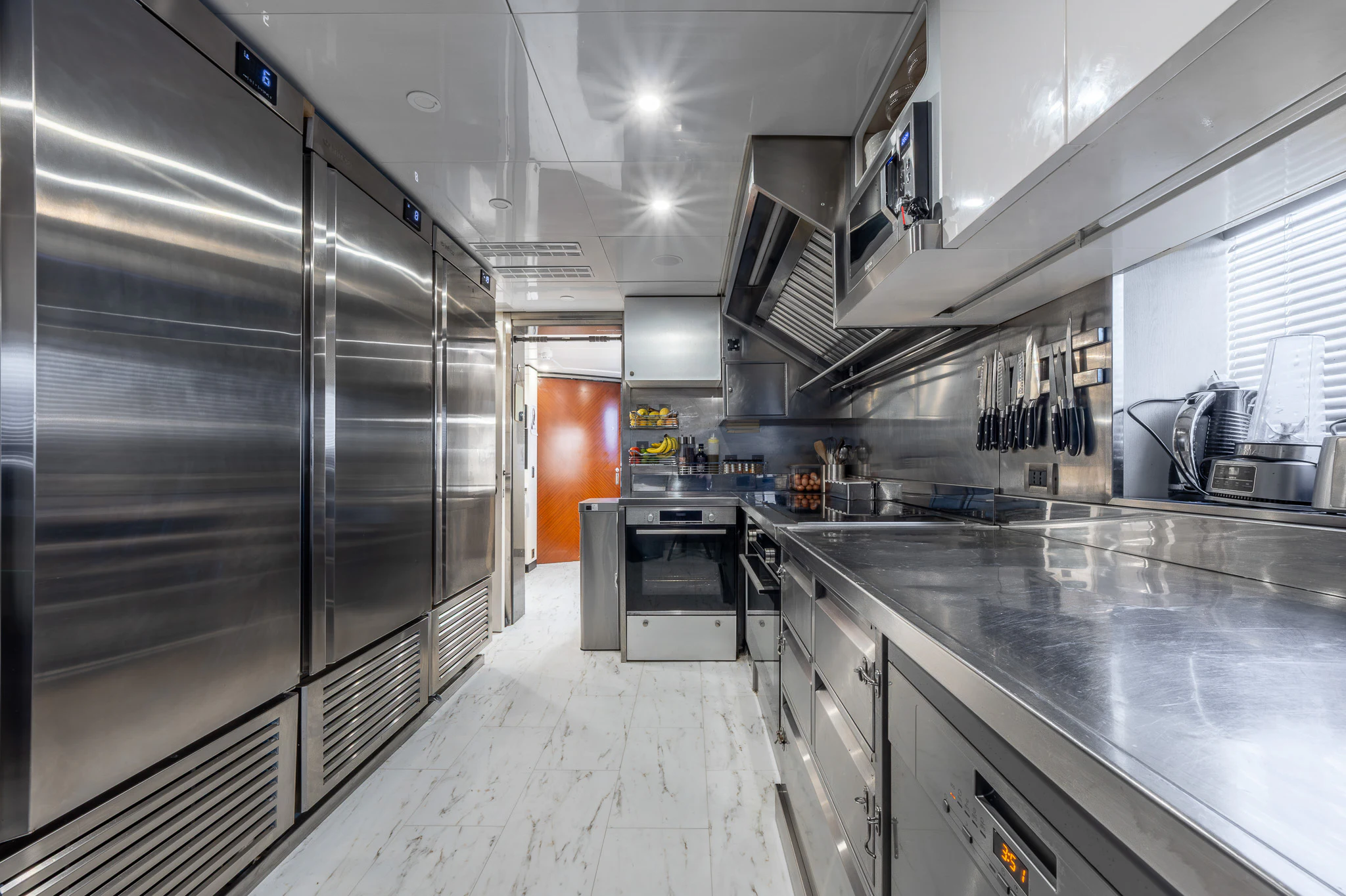 a kitchen with stainless steel appliances aboard TITIAN PEARL Yacht for Sale