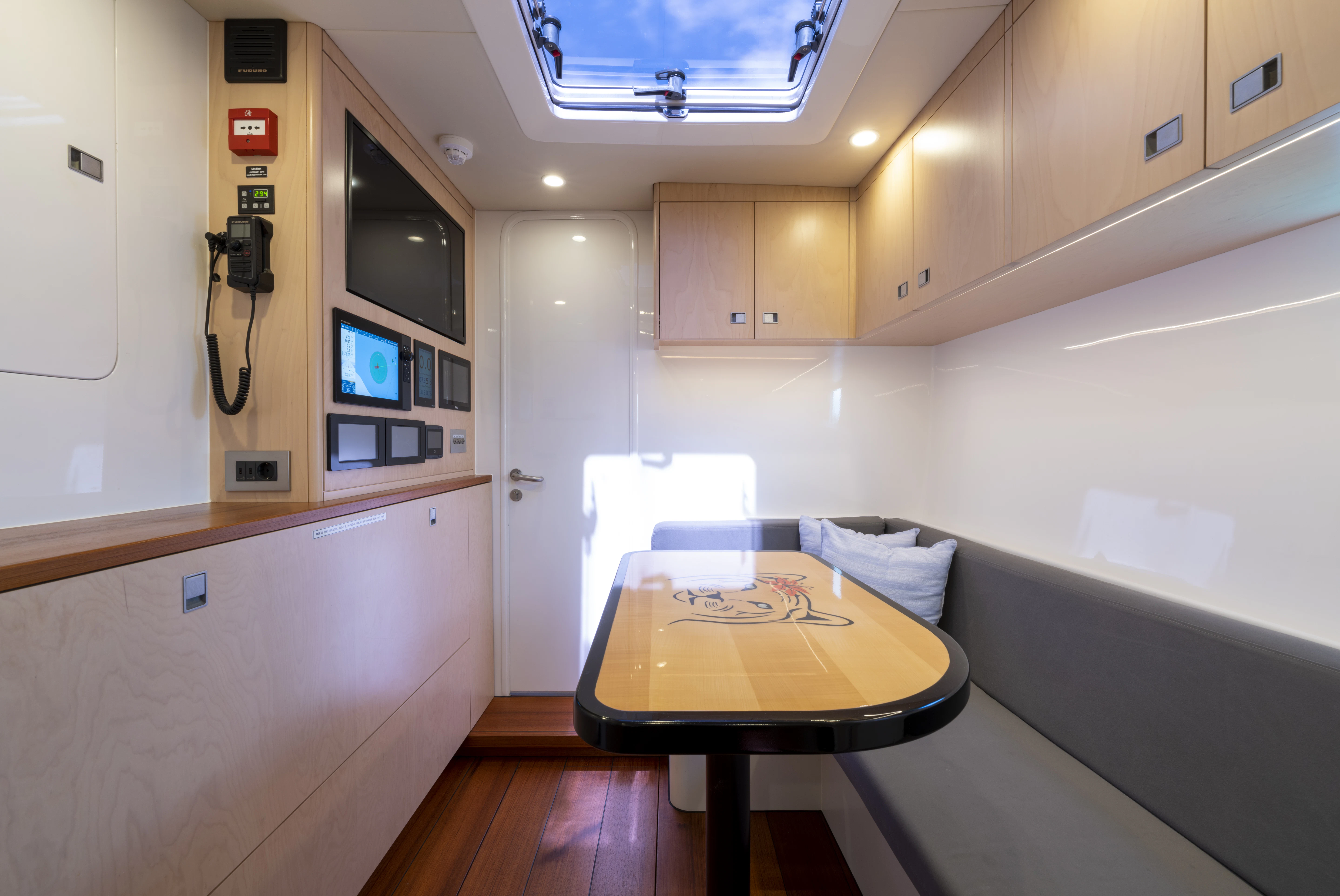 a room with a table and a bed aboard TIGER LILY TOO Yacht for Sale