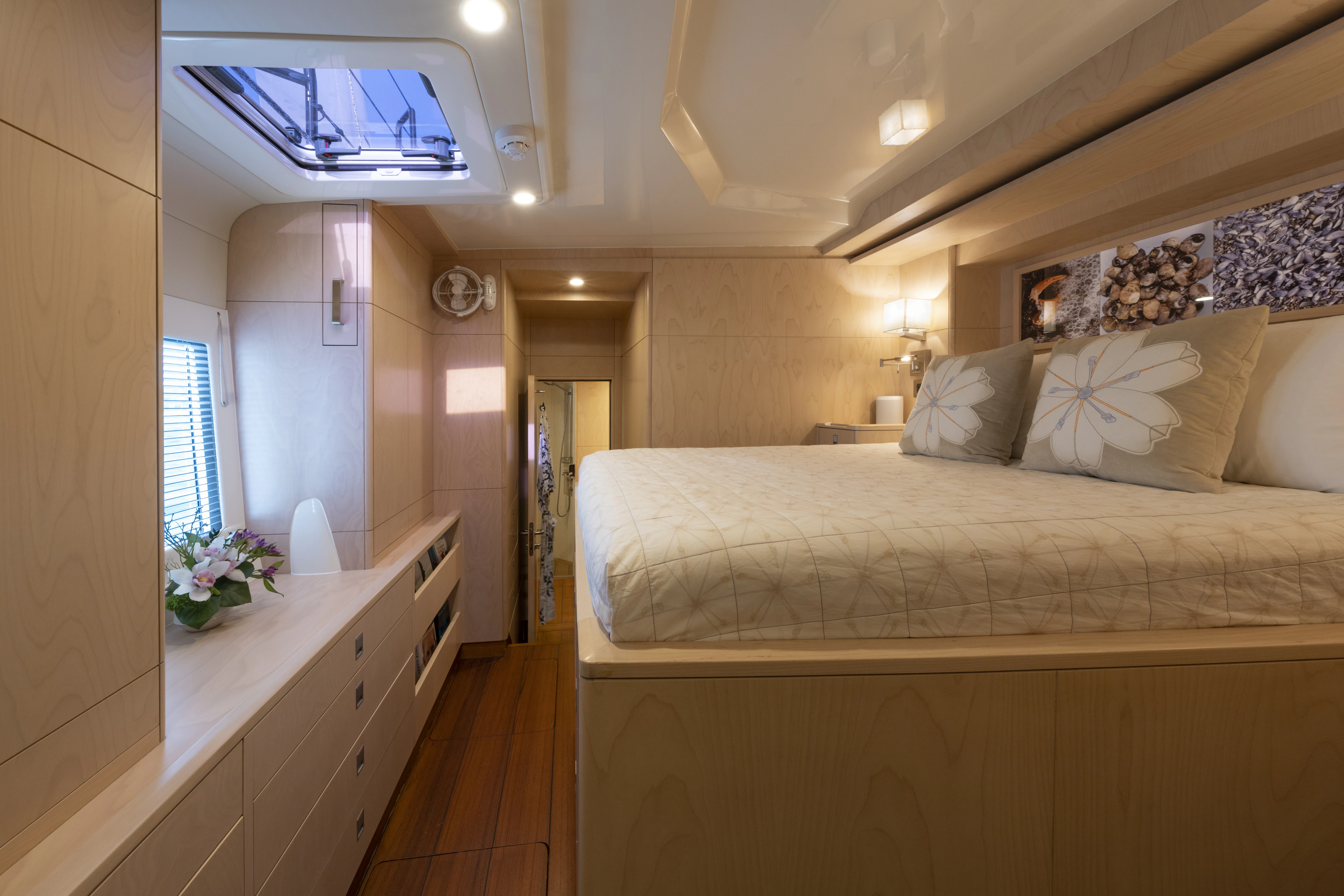 a bedroom with a bed and a window aboard TIGER LILY TOO Yacht for Sale
