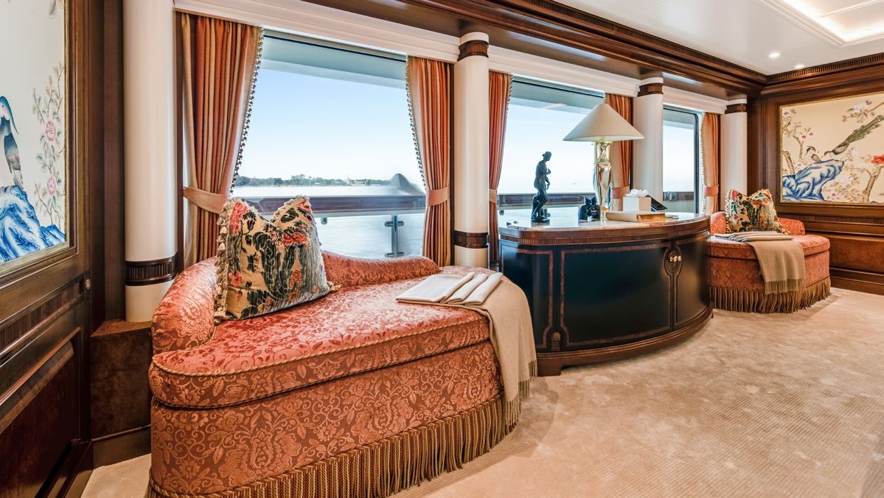 a bedroom with a bed and a desk aboard CALYPSO Yacht for Sale