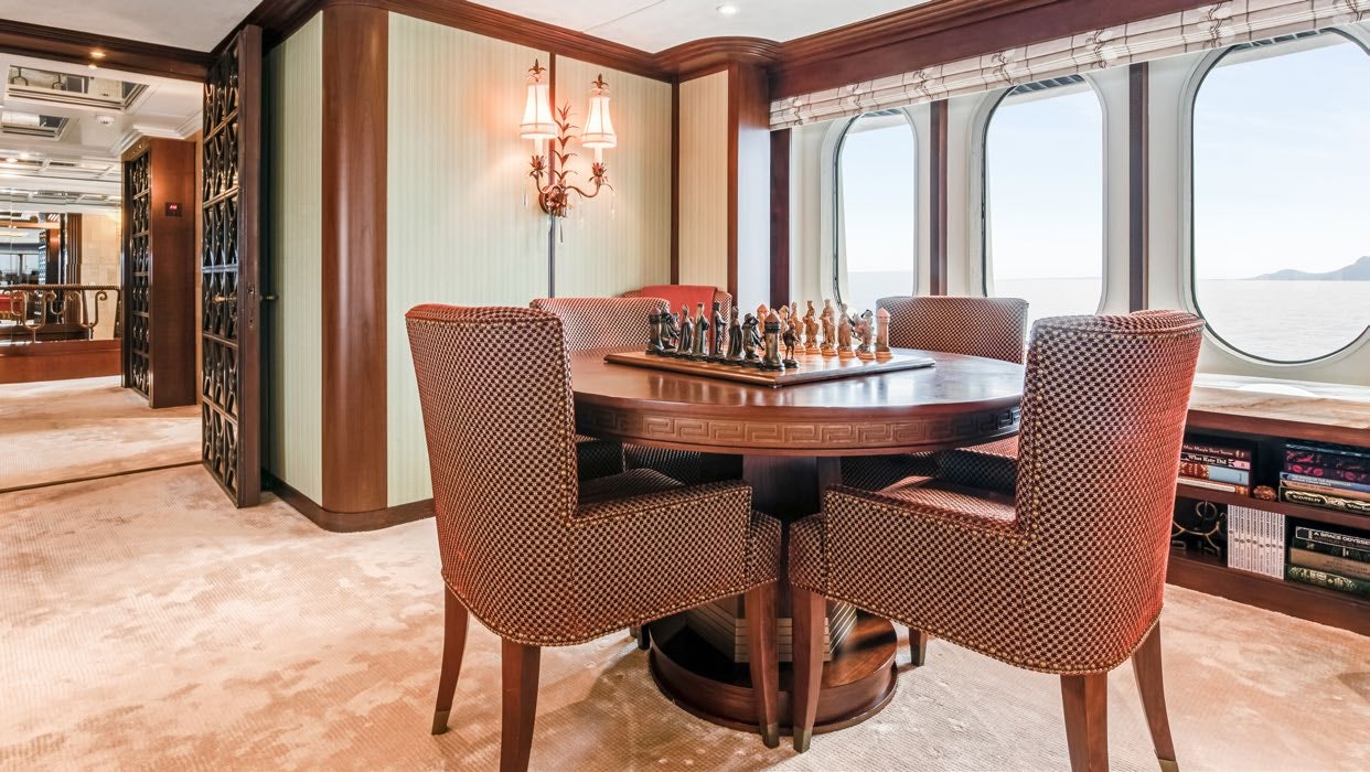 a dining room with a table and chairs aboard CALYPSO Yacht for Sale