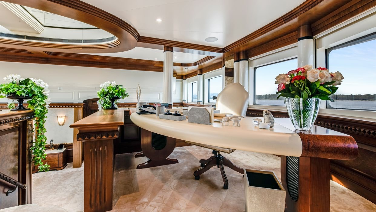a large room with a table and chairs aboard CALYPSO Yacht for Sale