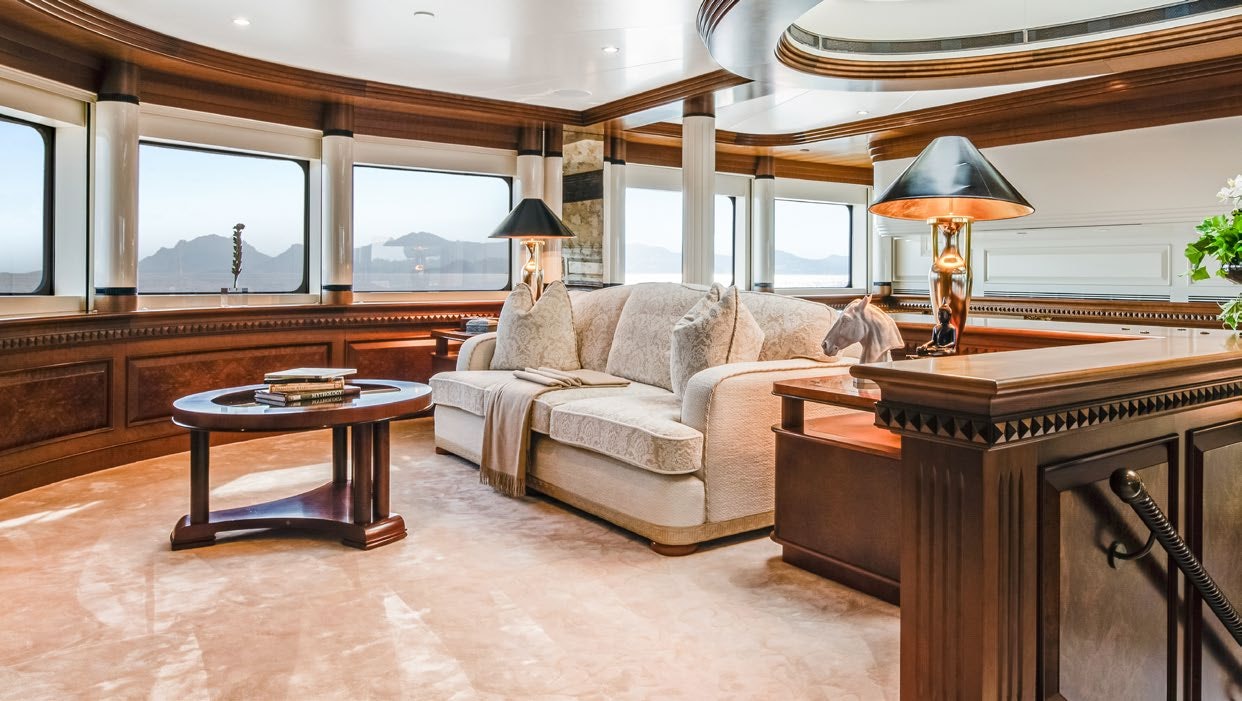 a living room with a couch and a table aboard CALYPSO Yacht for Sale
