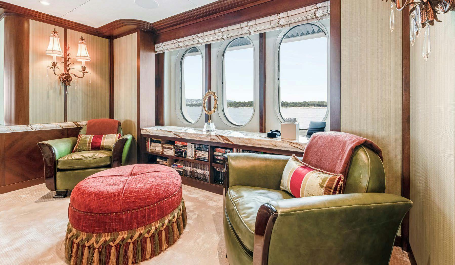 a living room with a table and chairs aboard CALYPSO Yacht for Sale