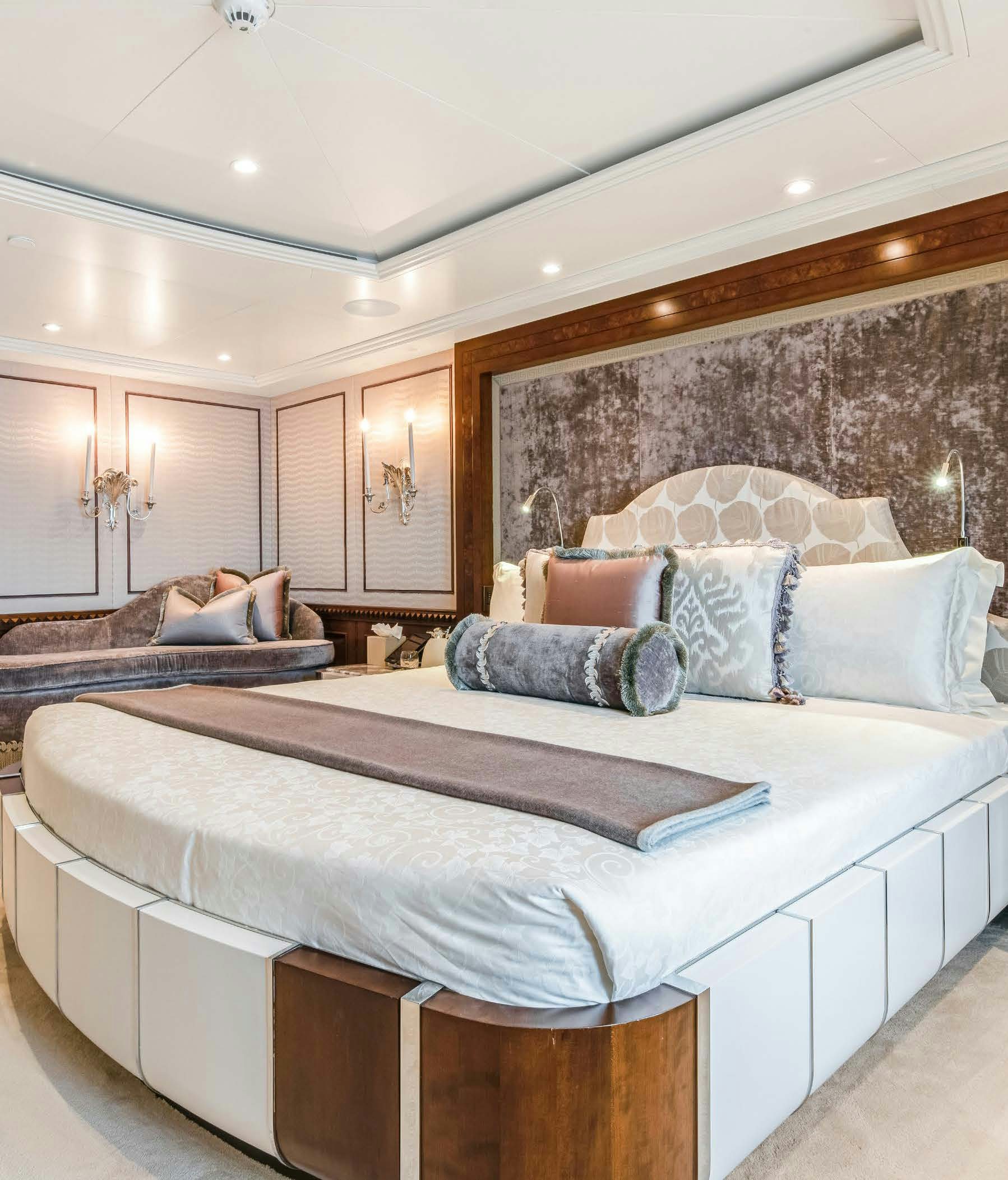 a bed with a blue pillow aboard CALYPSO Yacht for Sale