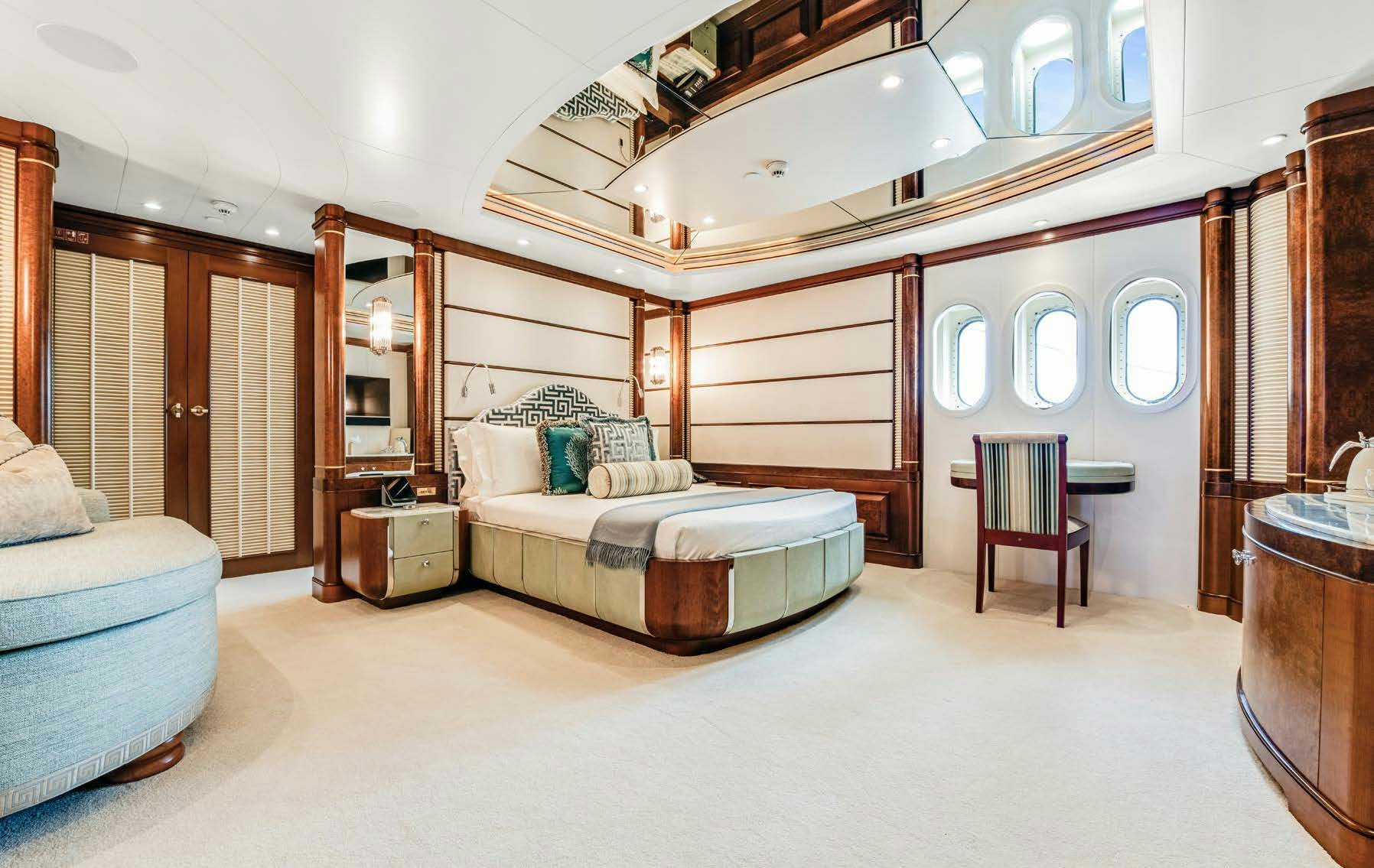 a bedroom with a bed and a chair aboard CALYPSO Yacht for Sale