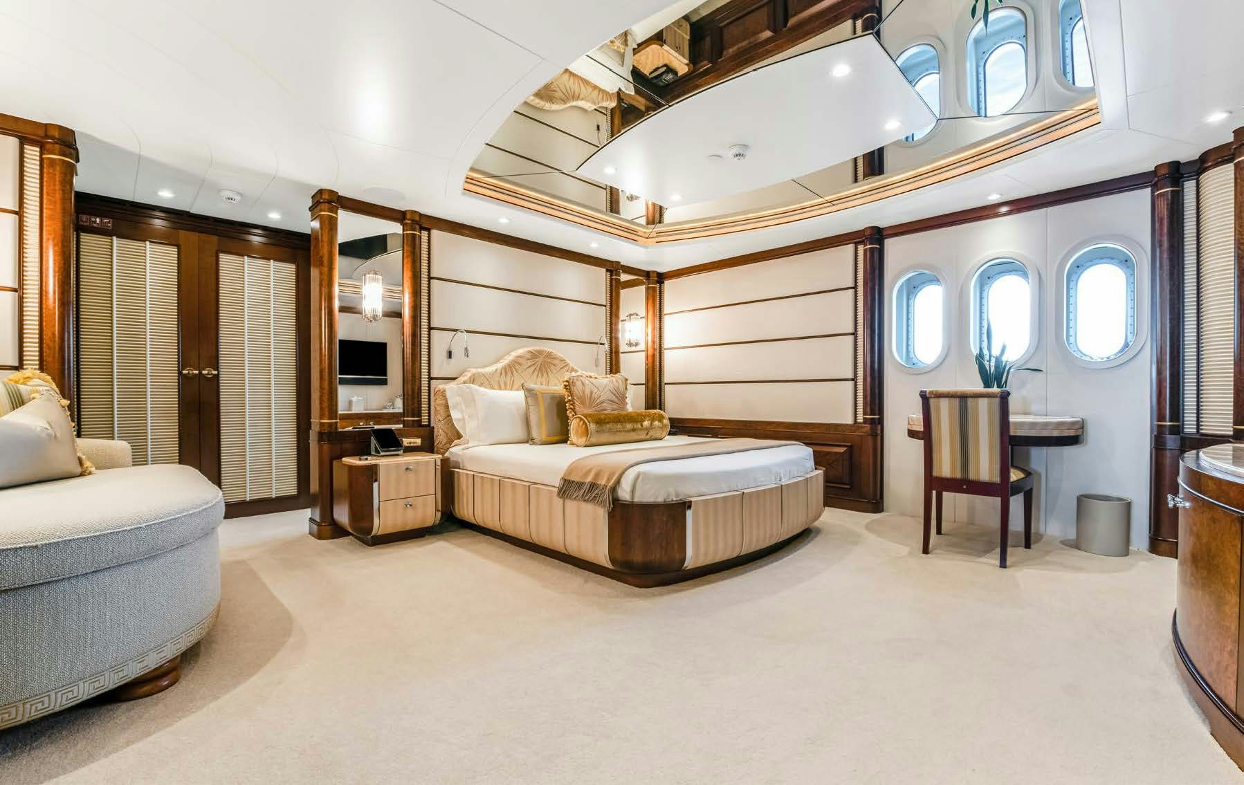 a large bedroom with a bed and a couch aboard CALYPSO Yacht for Sale