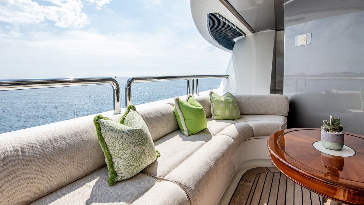 a couch with pillows and a table aboard CALYPSO Yacht for Sale
