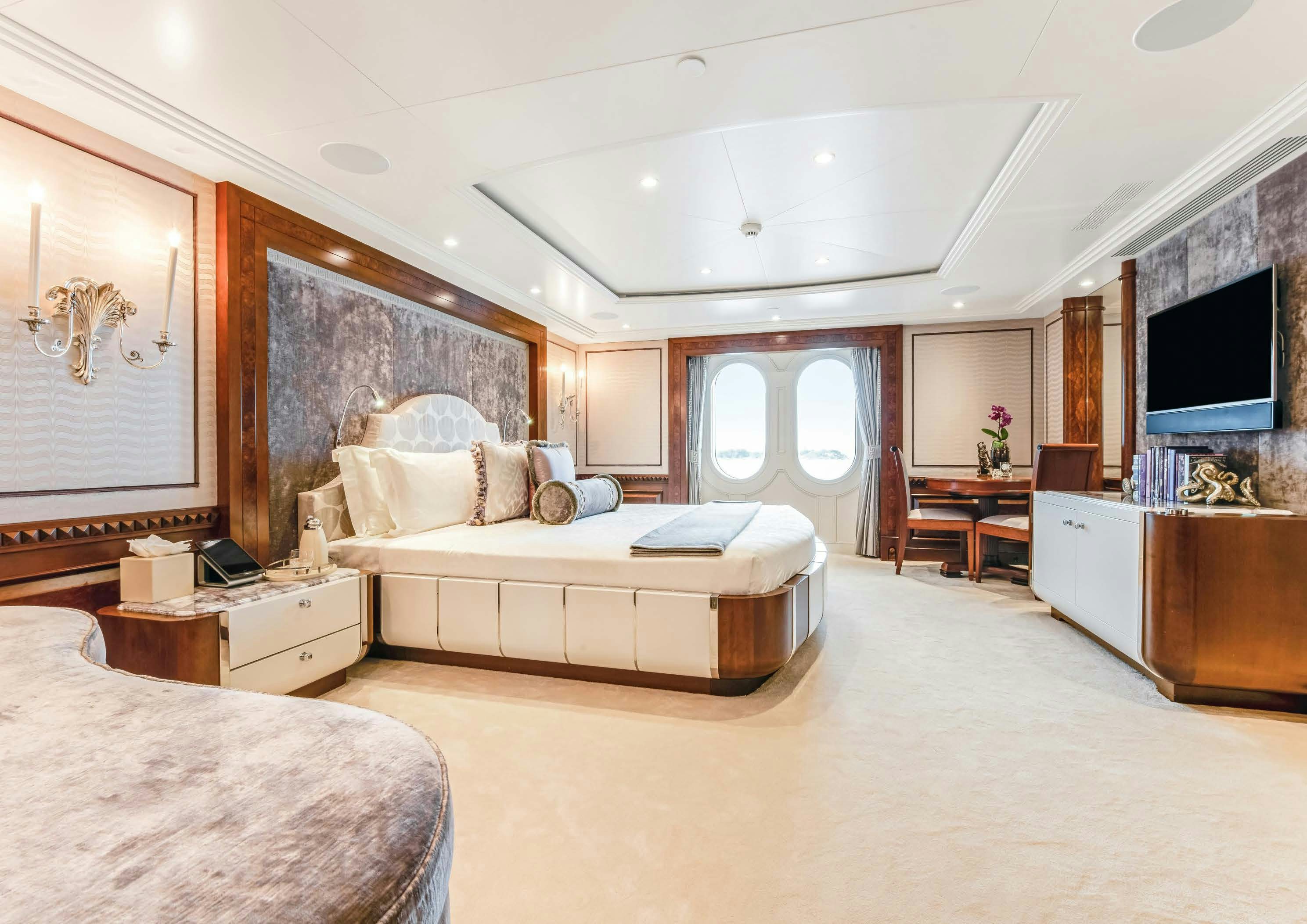 a bedroom with a bed and a tv aboard CALYPSO Yacht for Sale