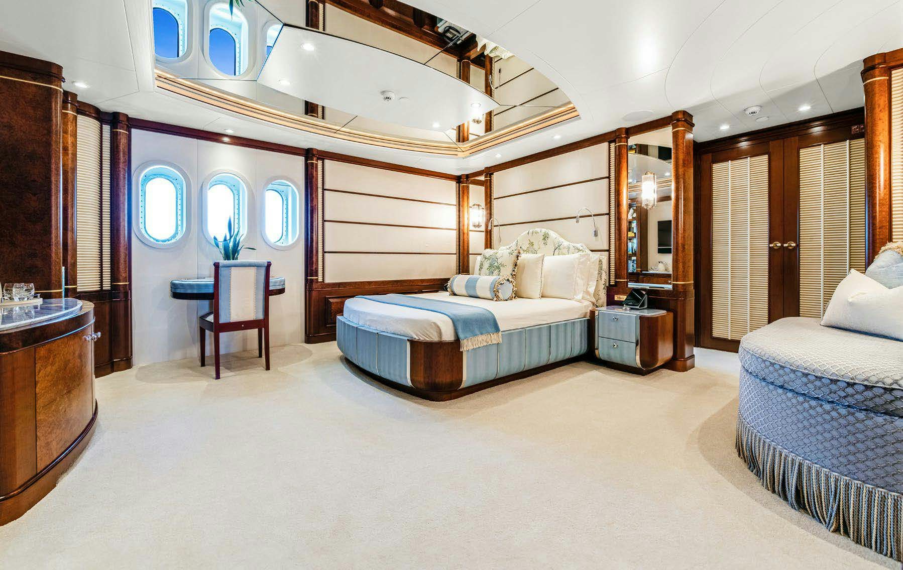 a bedroom with a bed and a desk aboard CALYPSO Yacht for Sale