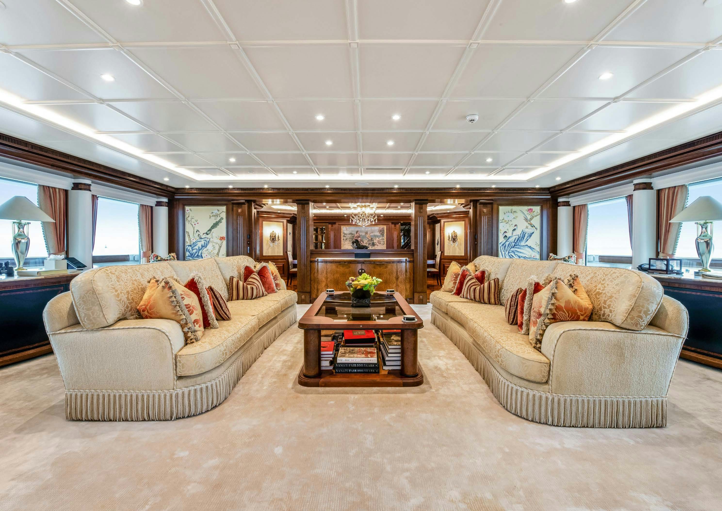 a living room with couches and a coffee table aboard CALYPSO Yacht for Sale