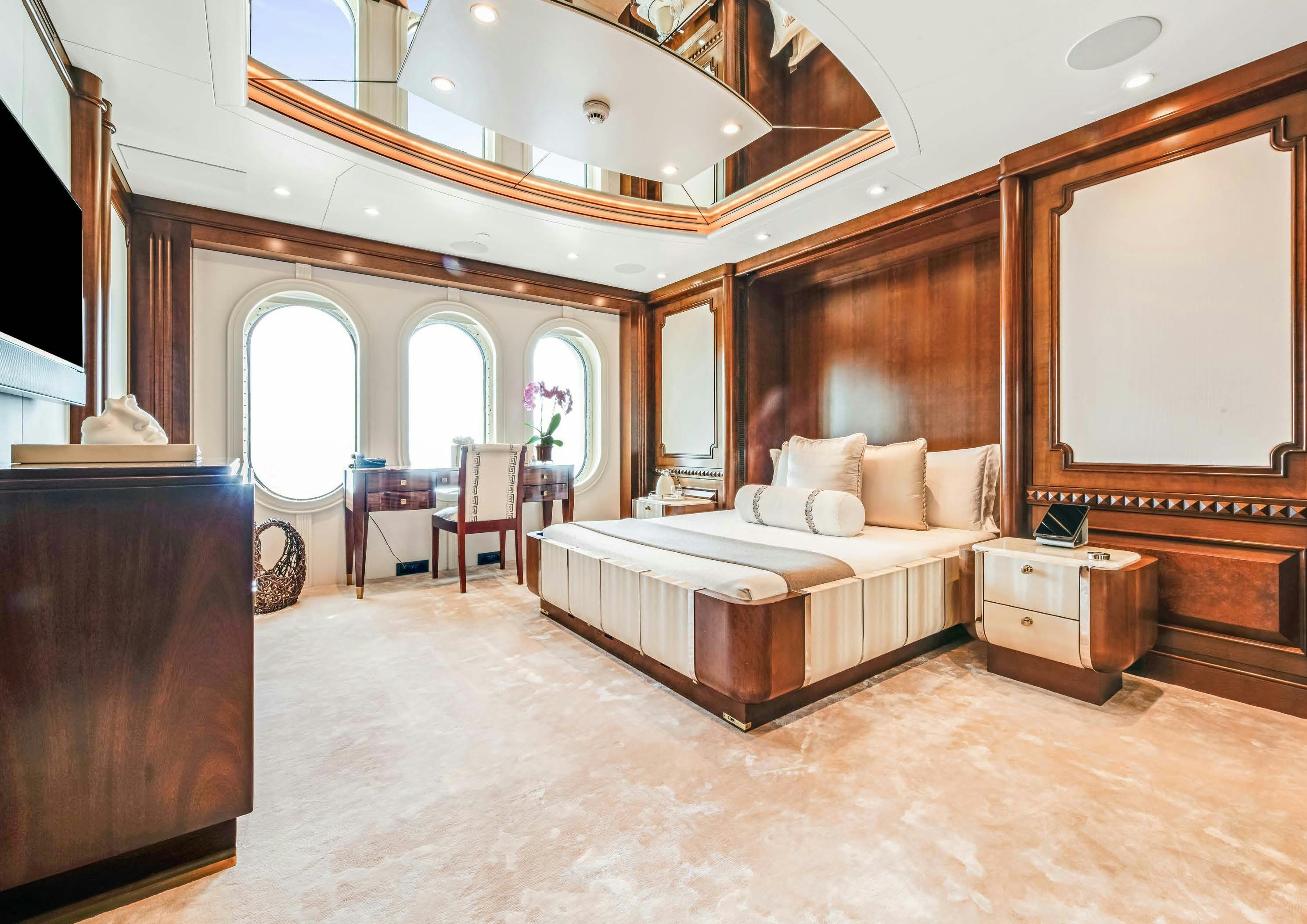 a large bedroom with a large mirror aboard CALYPSO Yacht for Sale