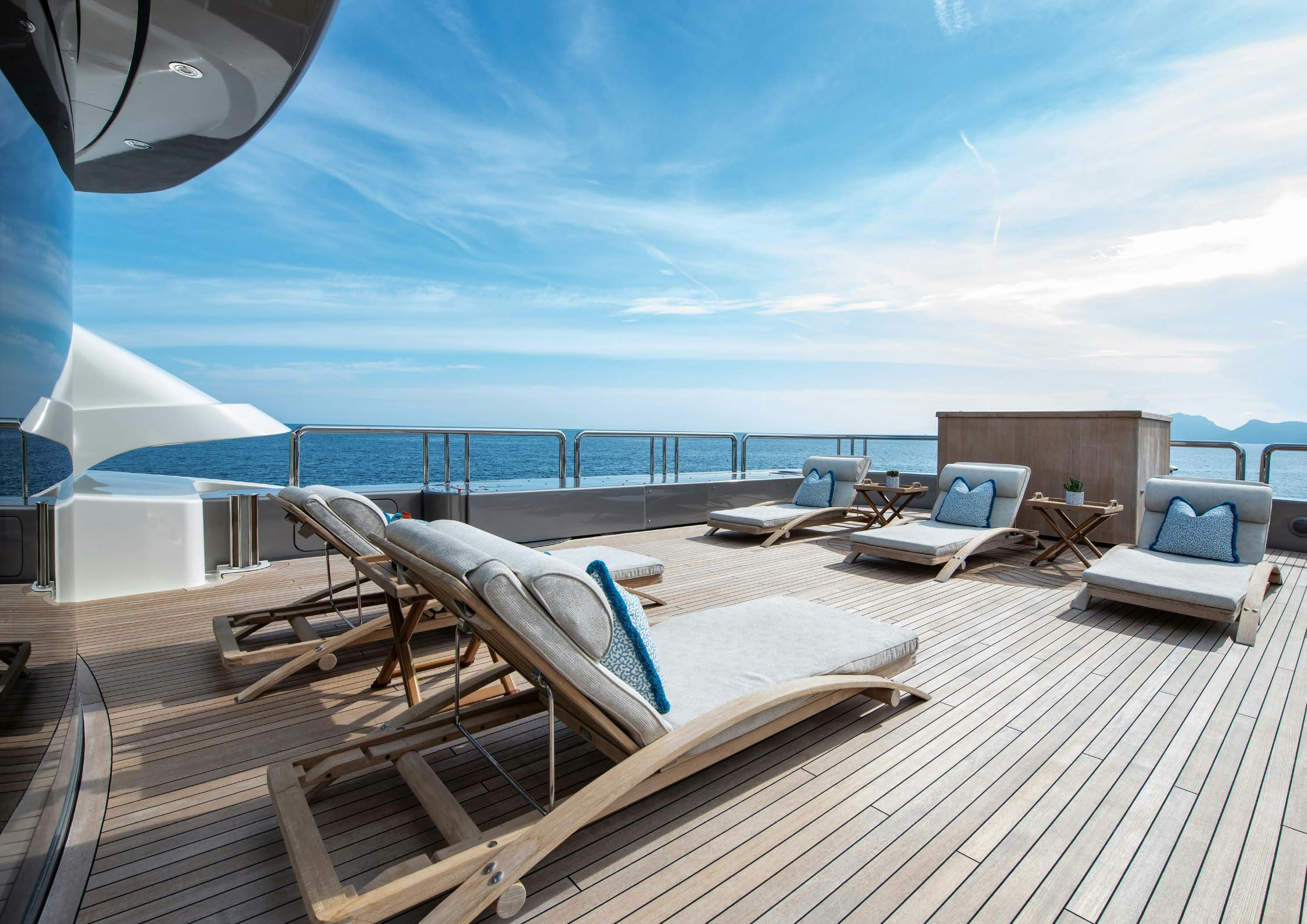 a deck with a large body of water and a couple of laptops on it aboard CALYPSO Yacht for Sale