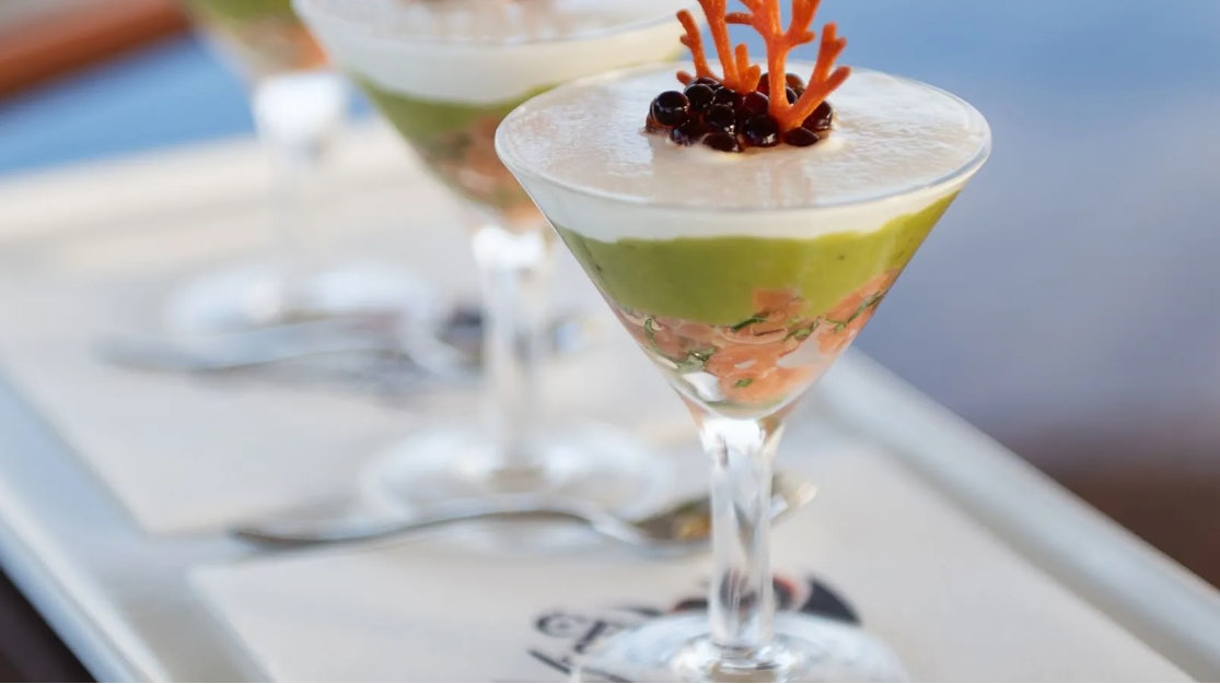 a glass with a drink in it aboard CROSSED SABRE Yacht for Charter