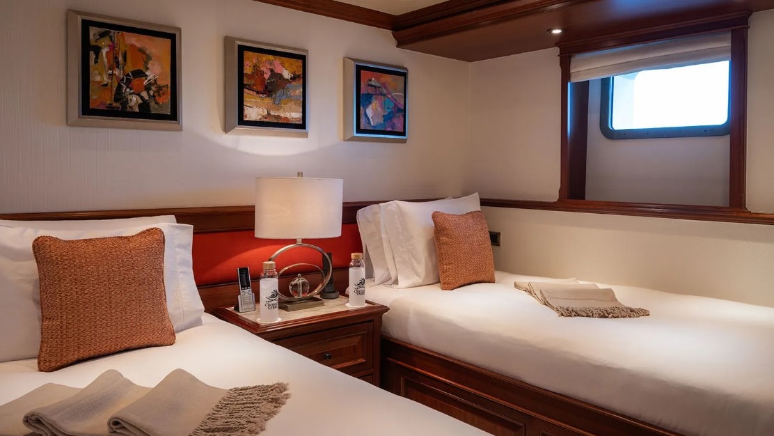 a hotel room with two beds aboard CROSSED SABRE Yacht for Charter