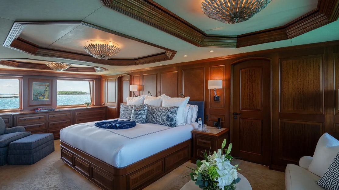 a large bedroom with a large bed aboard CROSSED SABRE Yacht for Charter