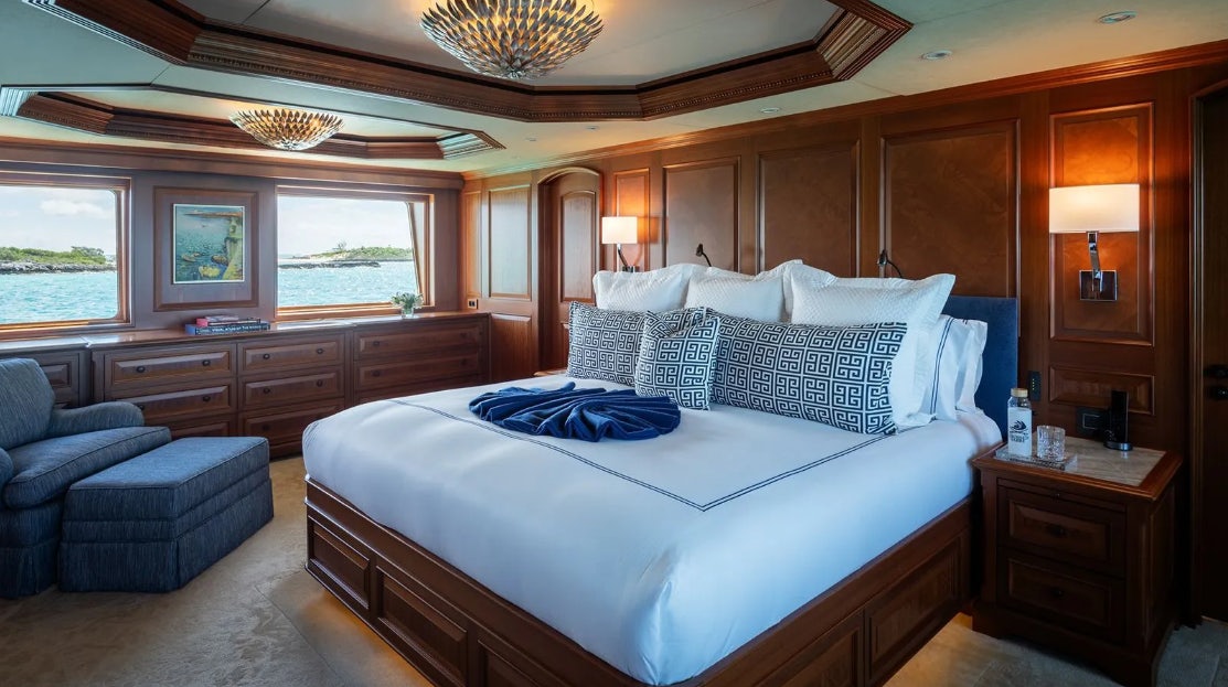 a large bed in a room aboard CROSSED SABRE Yacht for Charter