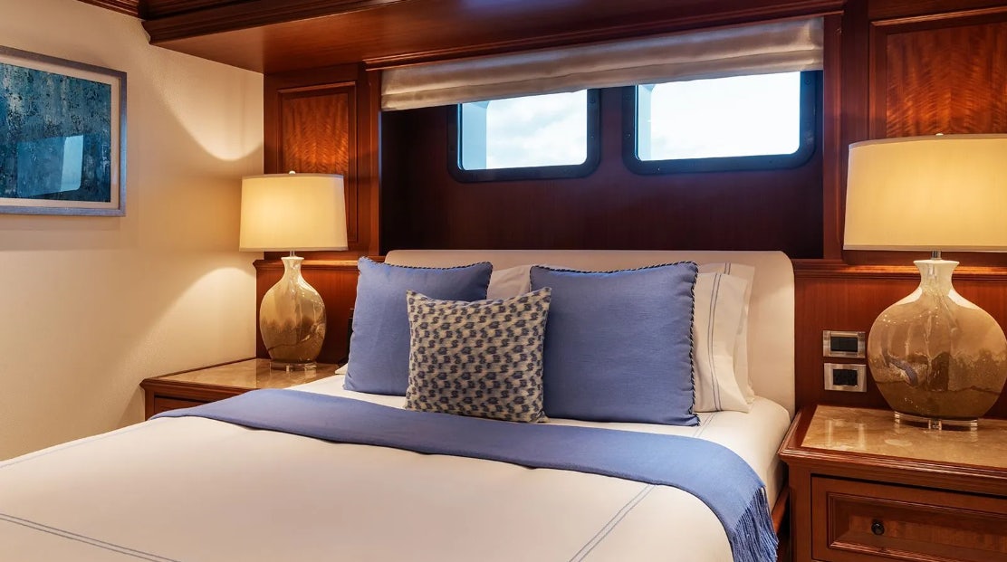 a bed with pillows aboard CROSSED SABRE Yacht for Charter