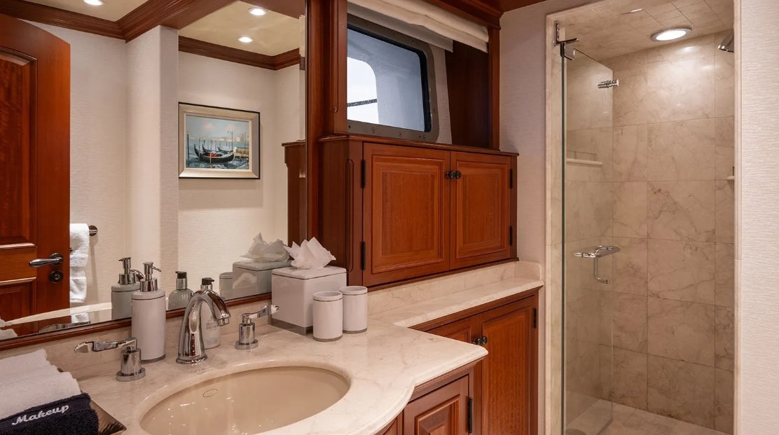 a bathroom with a glass shower aboard CROSSED SABRE Yacht for Charter