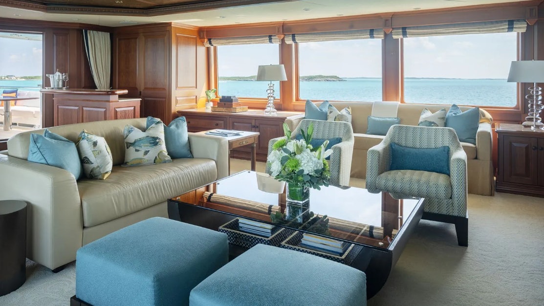 a living room with a couch and a coffee table aboard CROSSED SABRE Yacht for Charter