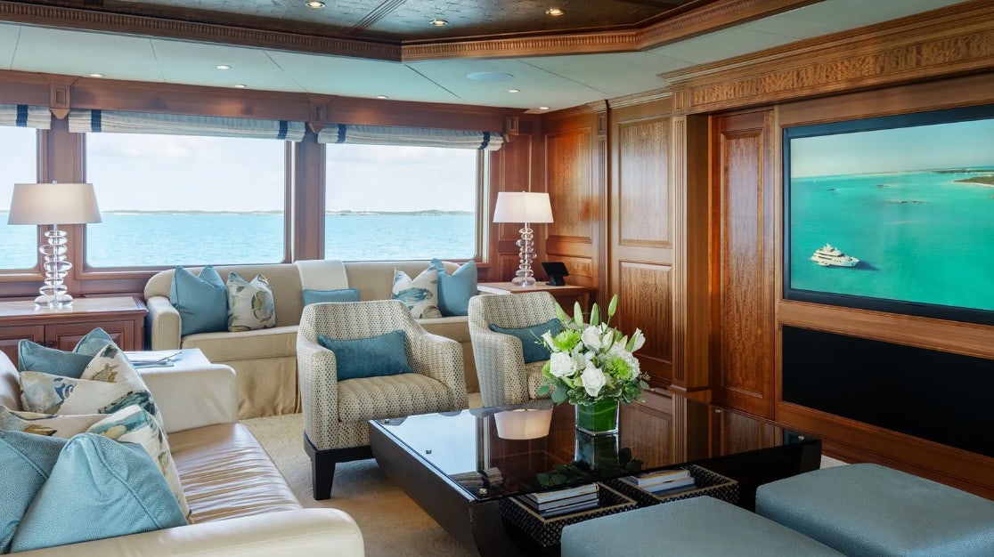 a living room with a large window aboard CROSSED SABRE Yacht for Charter
