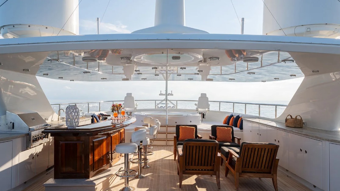 a room with tables and chairs aboard CROSSED SABRE Yacht for Charter