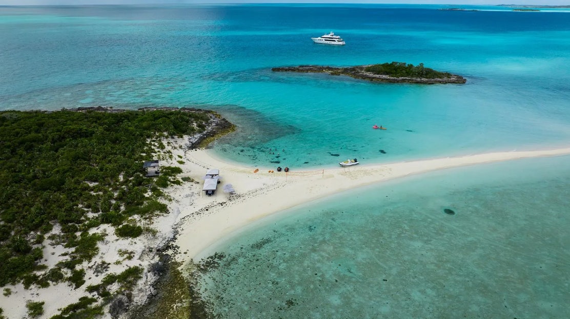 a beach with a few boats aboard CROSSED SABRE Yacht for Charter