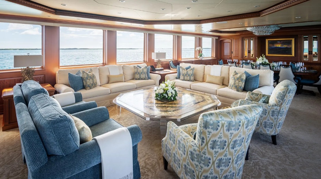 a living room with a large window aboard CROSSED SABRE Yacht for Charter