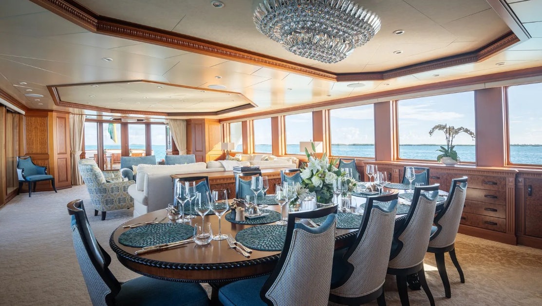 a large dining room with a large table and chairs aboard CROSSED SABRE Yacht for Charter