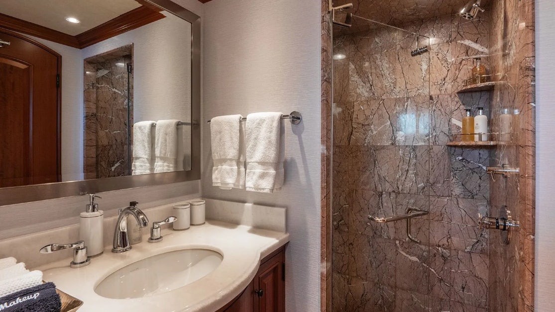 a bathroom with a large mirror aboard CROSSED SABRE Yacht for Charter